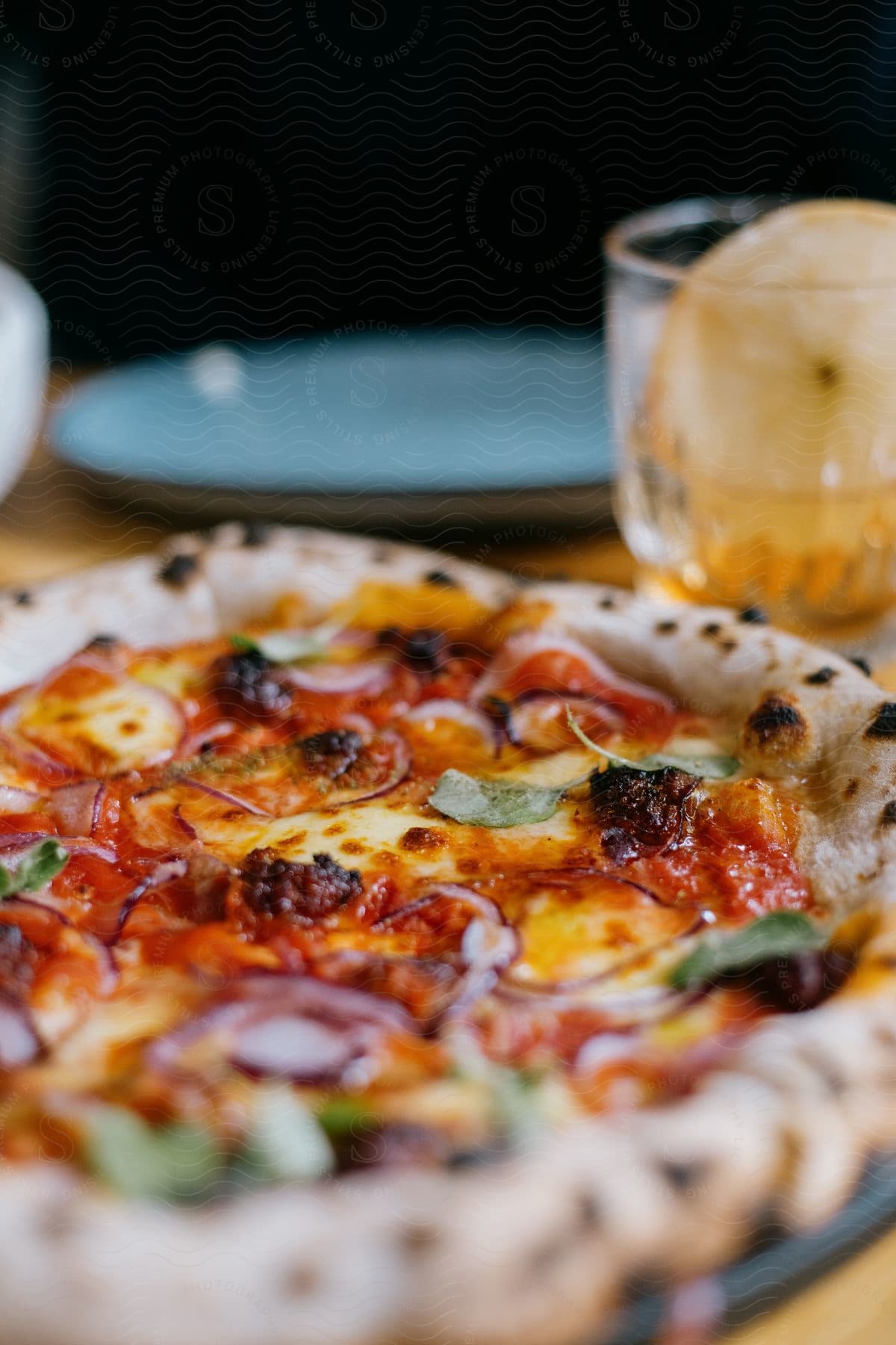 A table with baked goods dishes tableware and a pizza with cheese