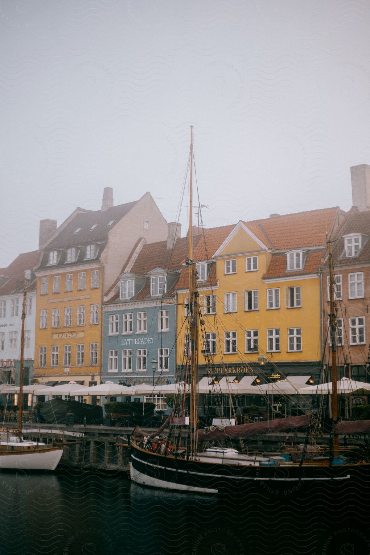 Colorful houses line a canal with boats in copenhagen