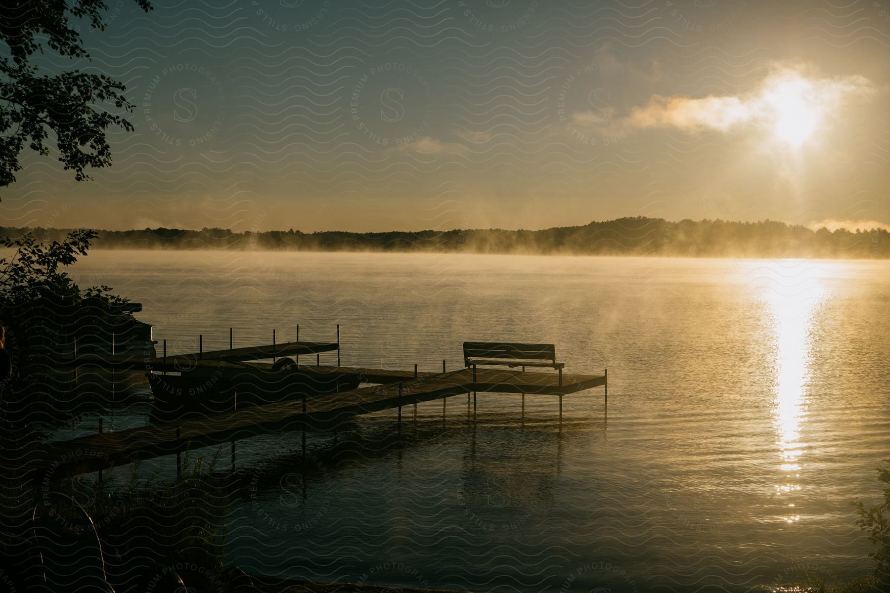 A Mistcovered Lake At Sunset With A Pier