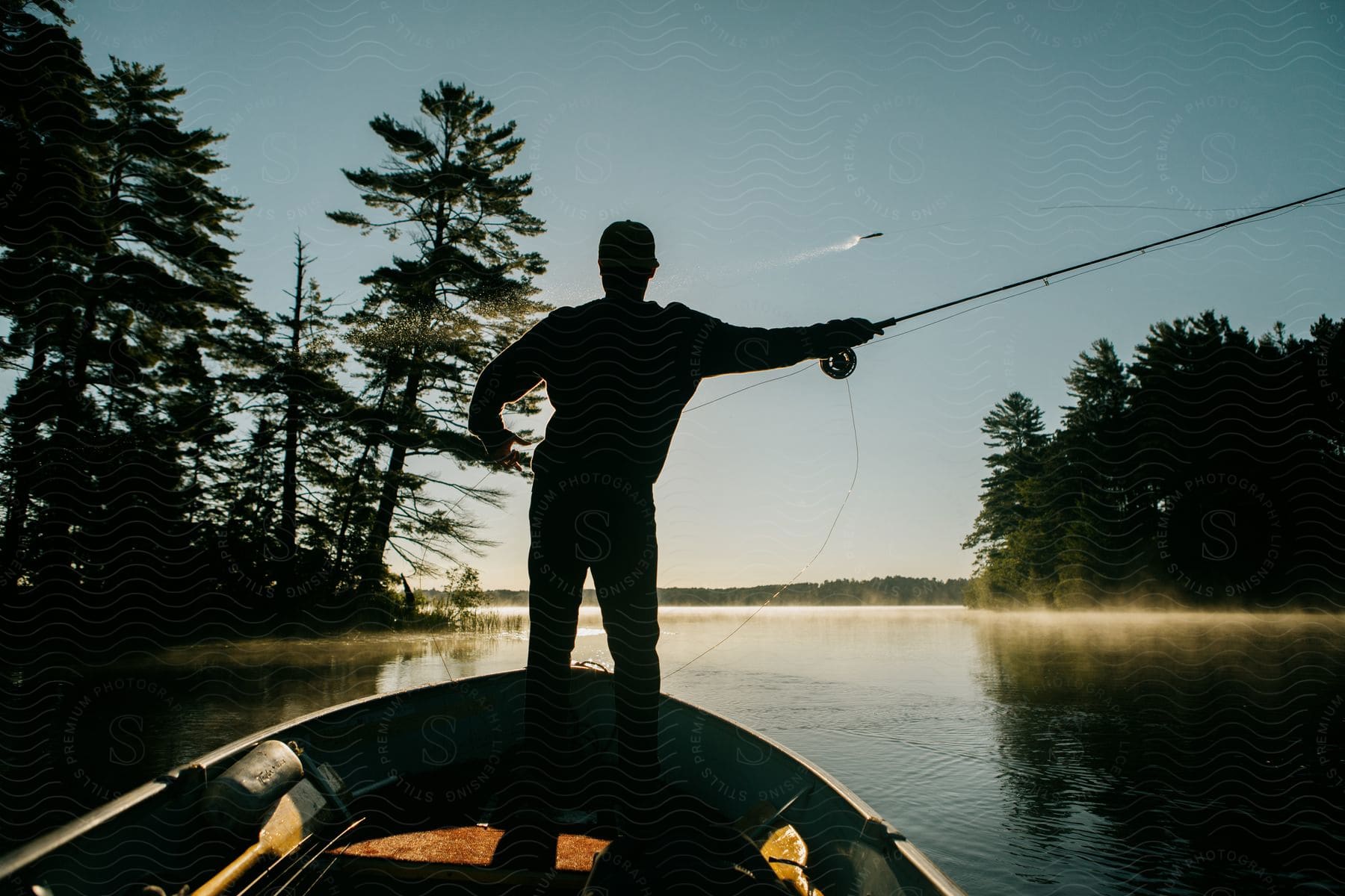 Fisherman In Boat Casting Line In River, Stock Image 3275