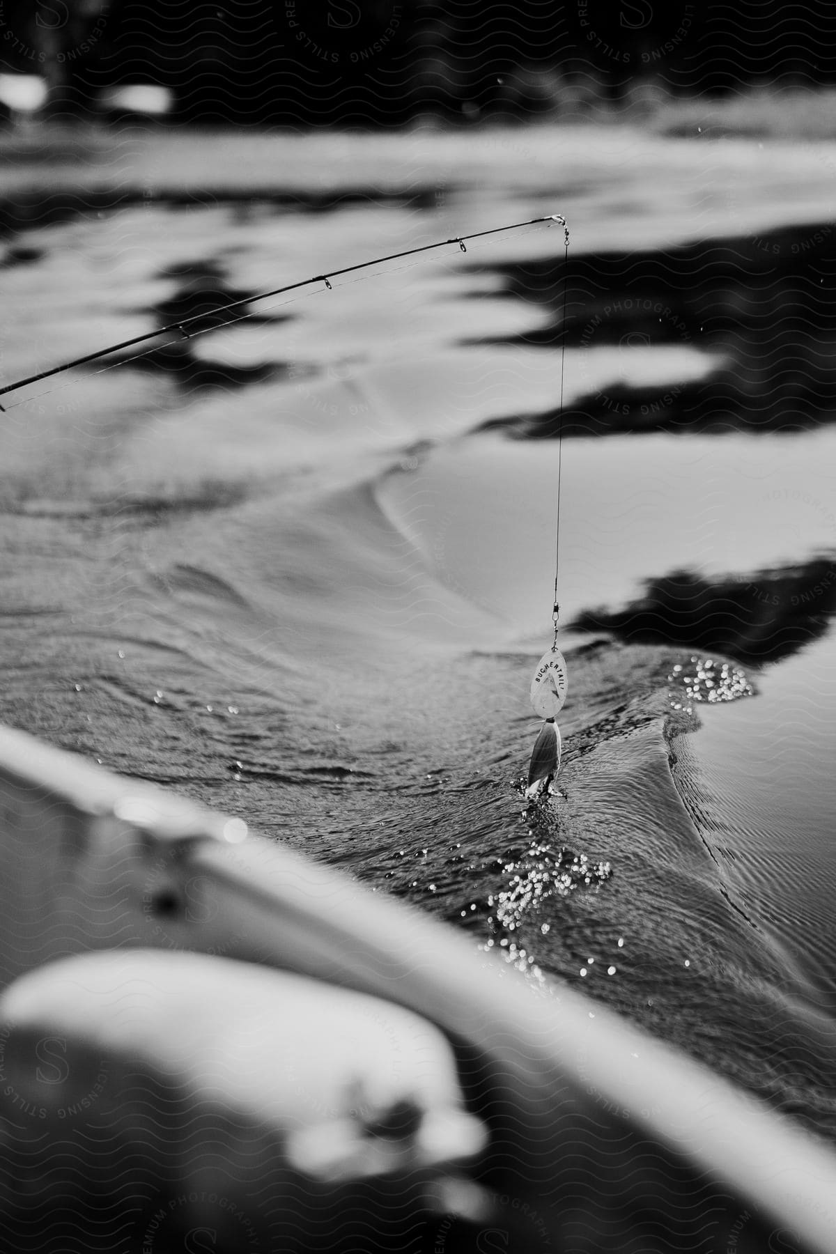 Fish hook touching the water in a lake in the wisconsin north woods