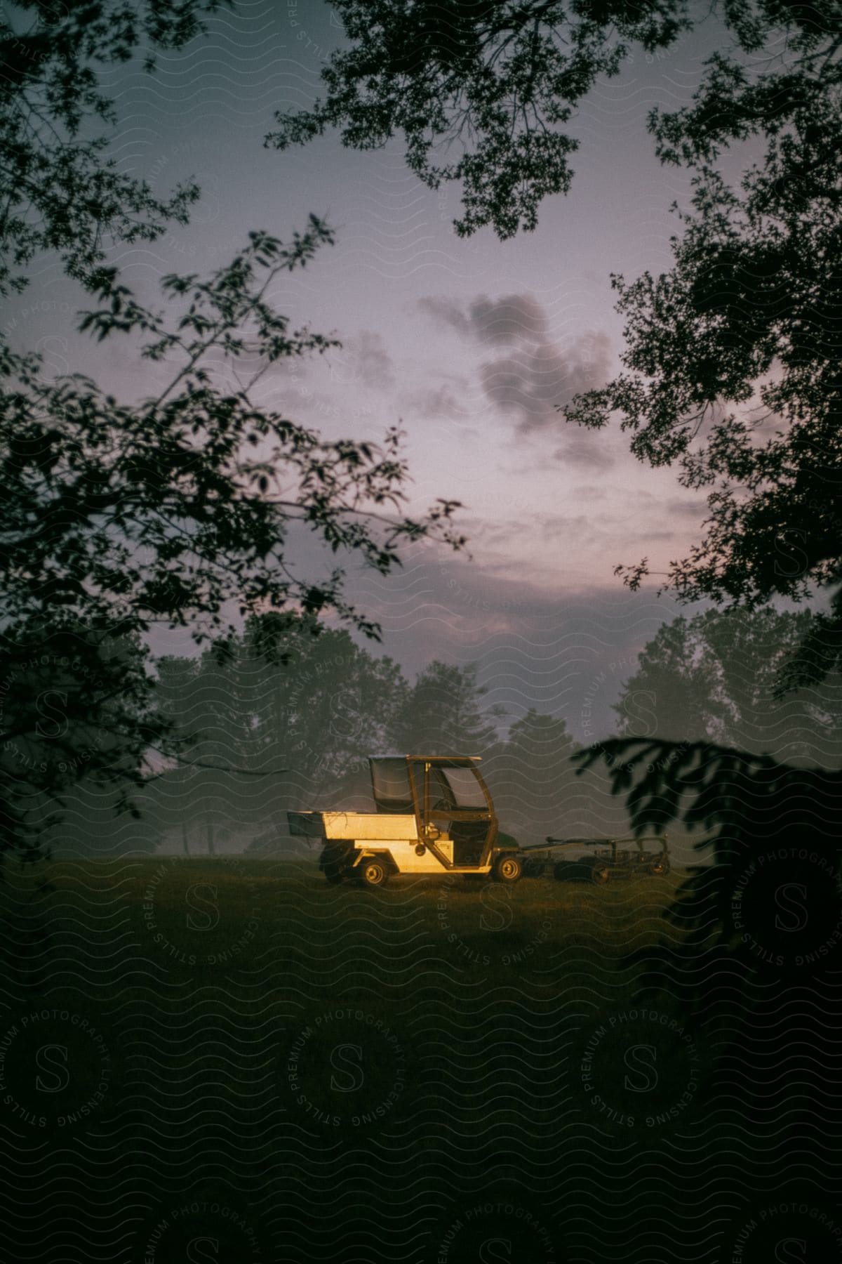 A utv drives across a golf course with a golf cart picker on the front