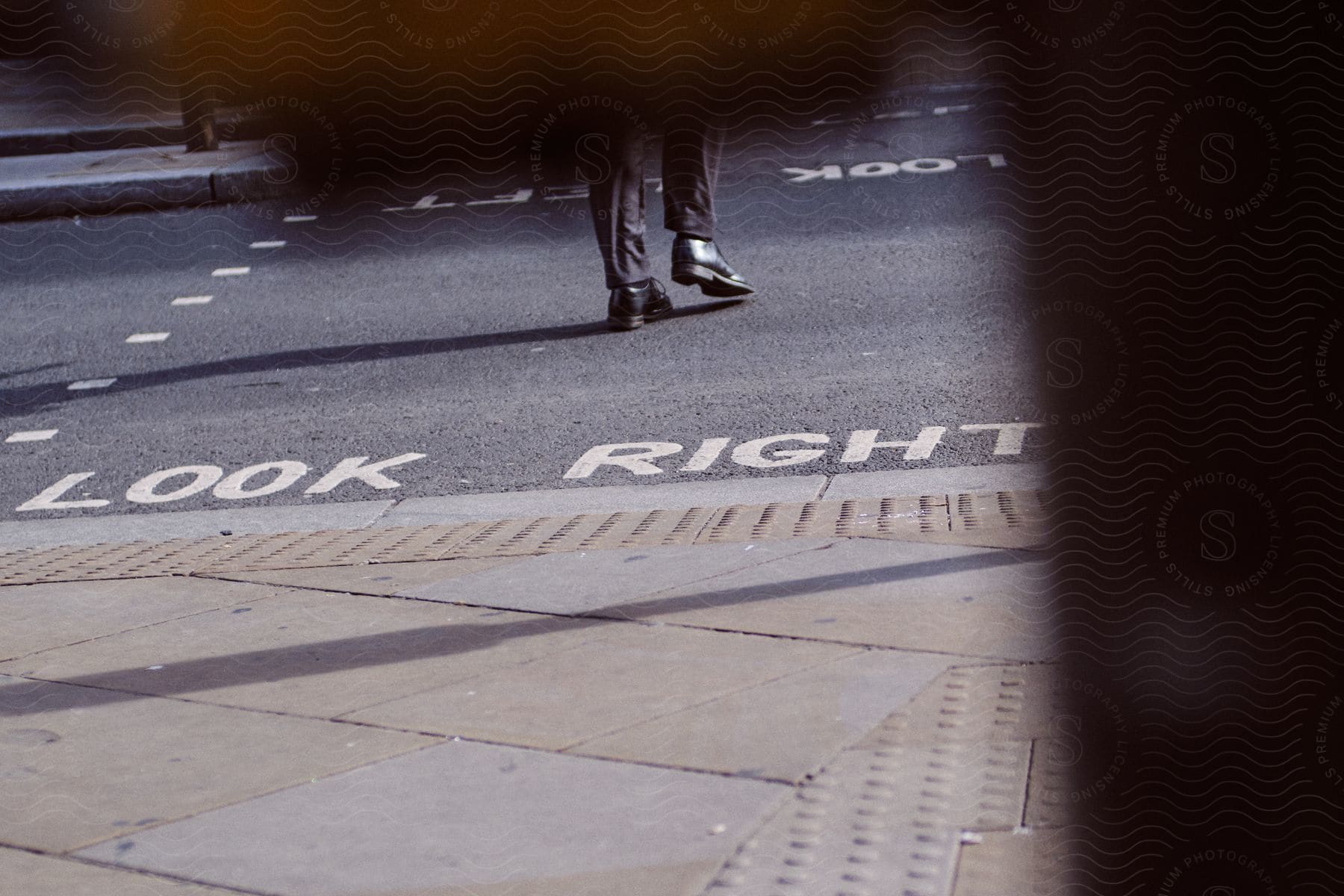 Street road with traffic signs written in white paint on the floor