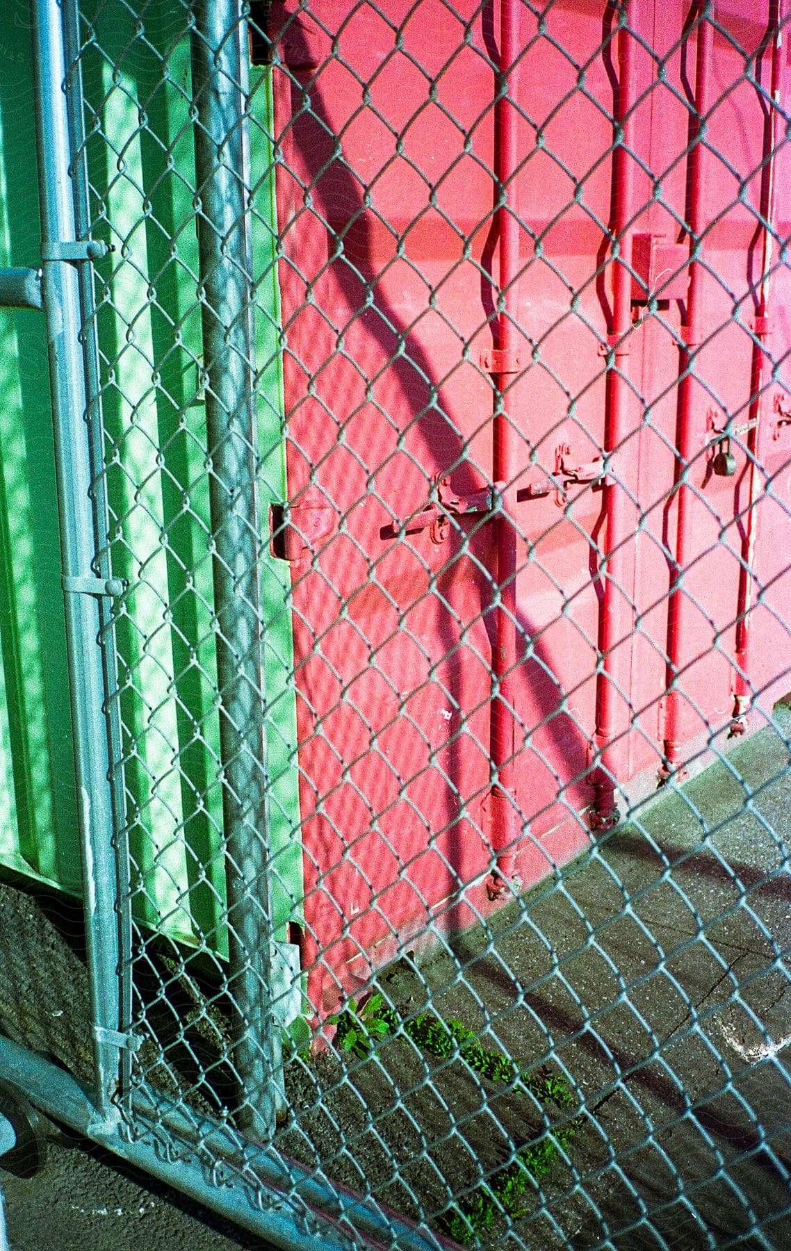 Commercial shipping container behind a chainlink fence