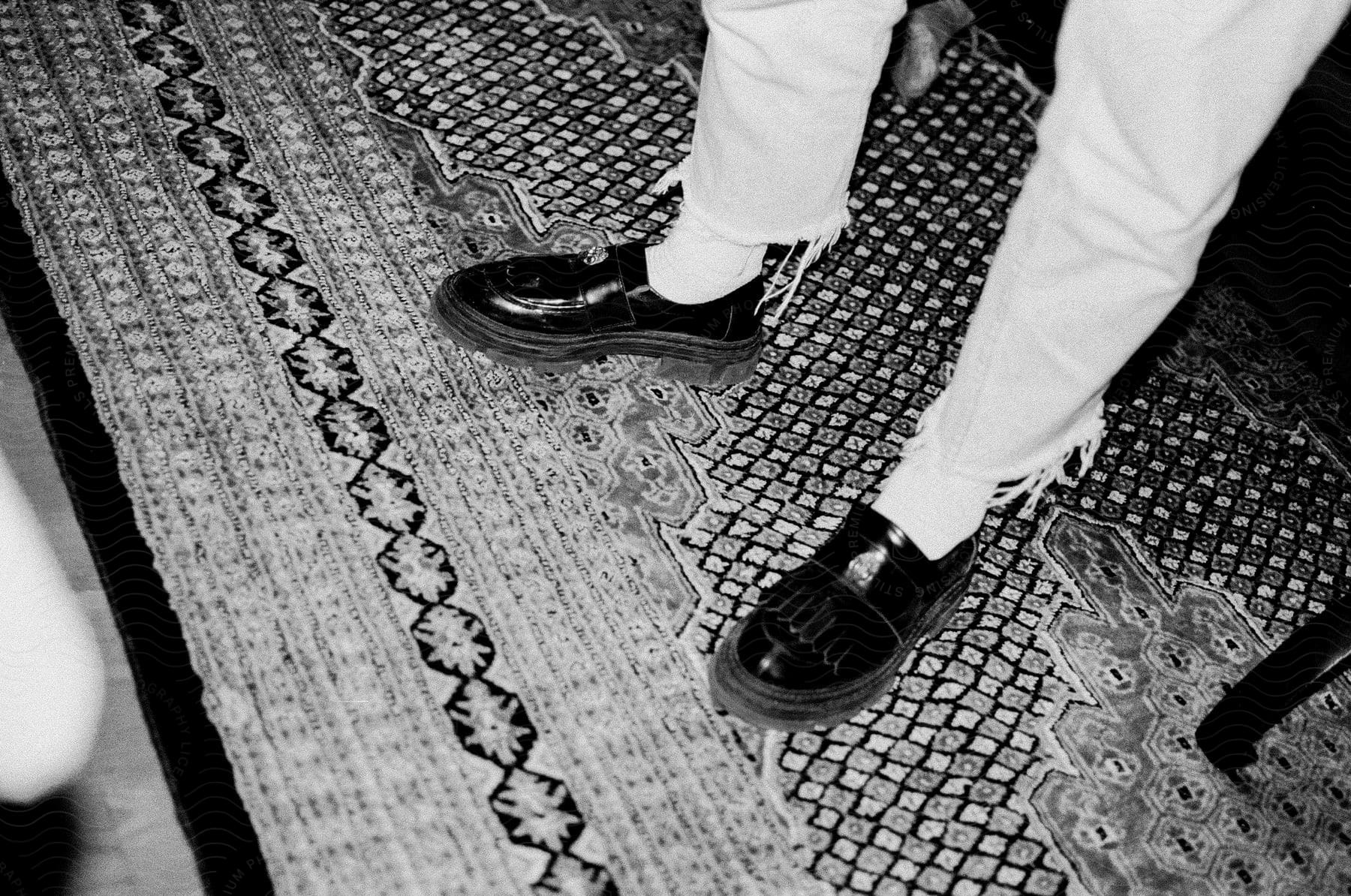 Black and white shot of shiny black mens dress shoes on a floor