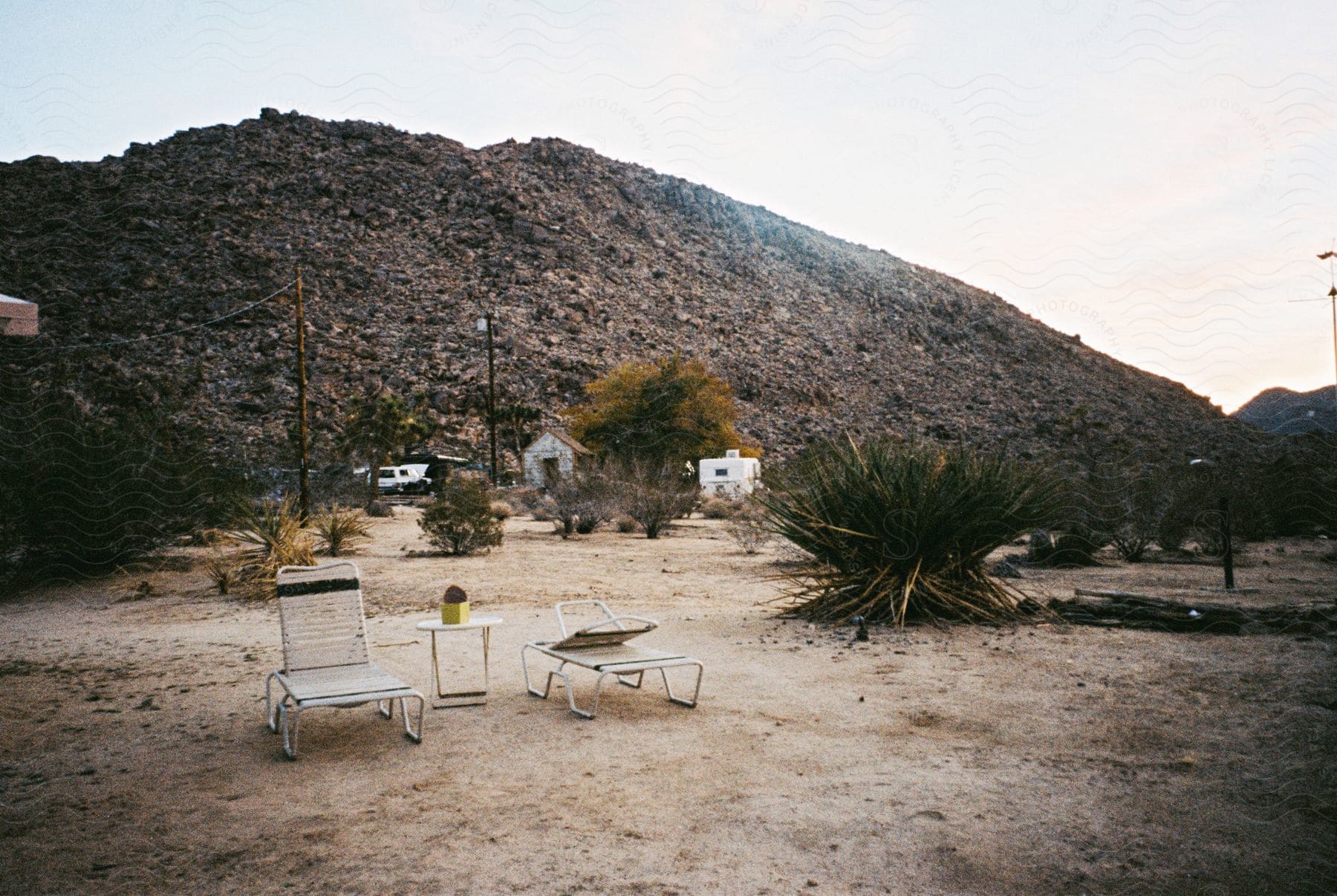 A serene mountain landscape with a table and chair in the outdoors