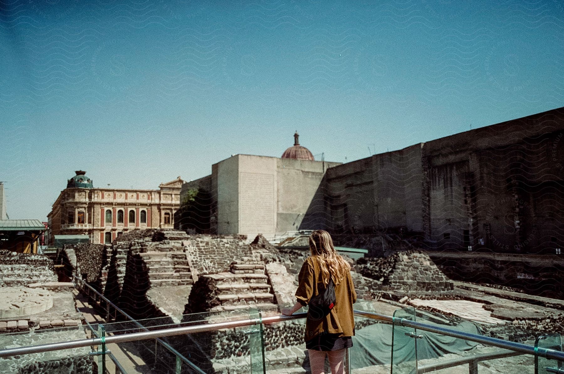 Tourist observing ancient ruins in templo mayor museum in mexico city