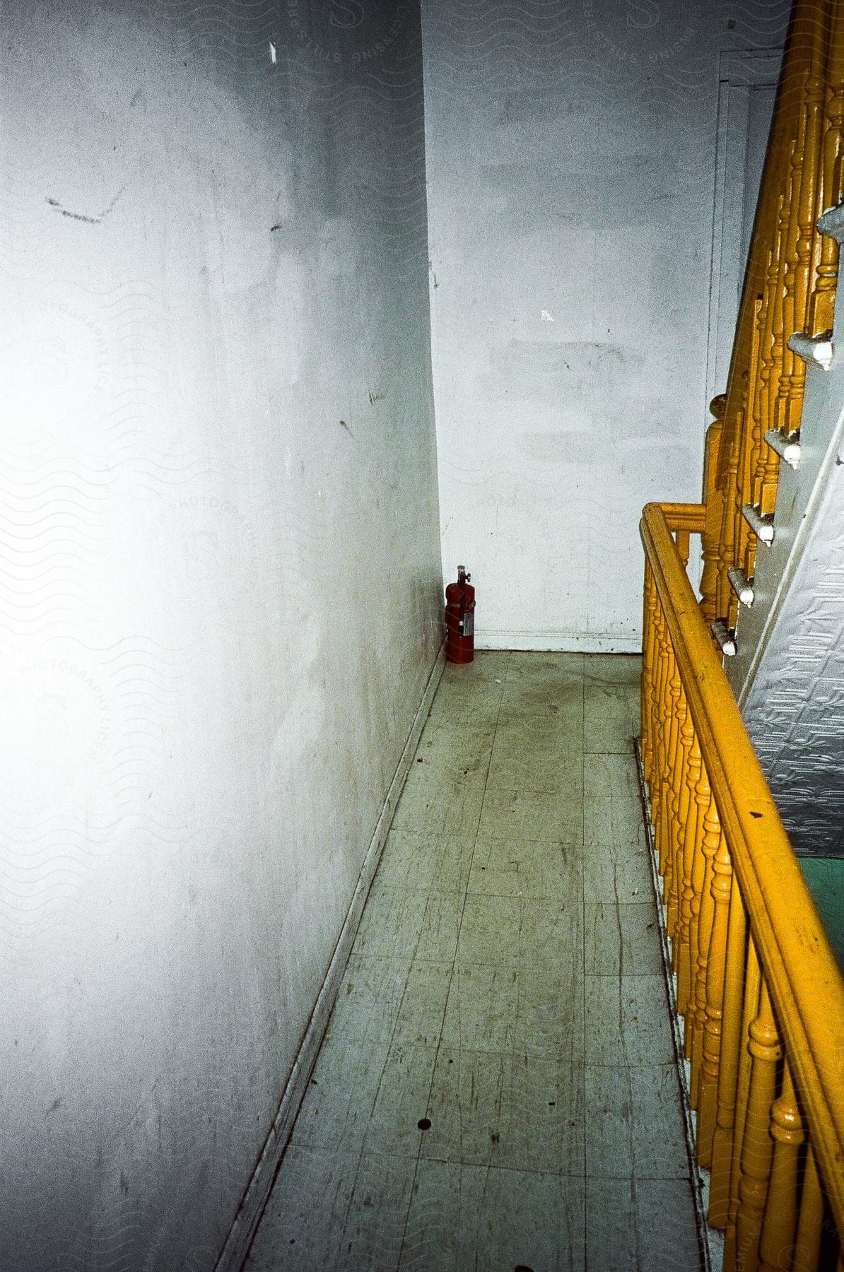 Interior of dark building with stairs with yellow handrail