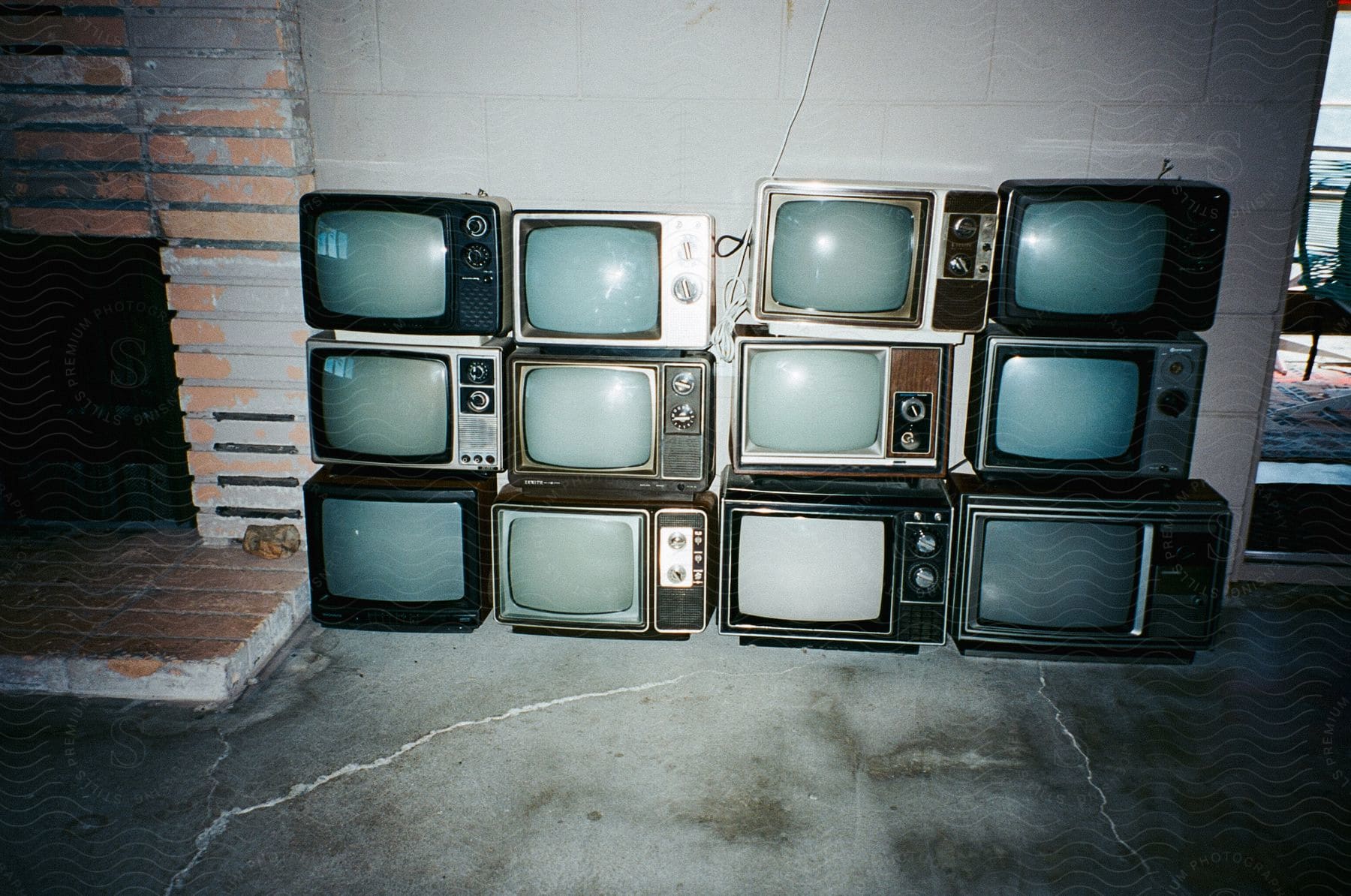 Retro televisions stacked against a wall