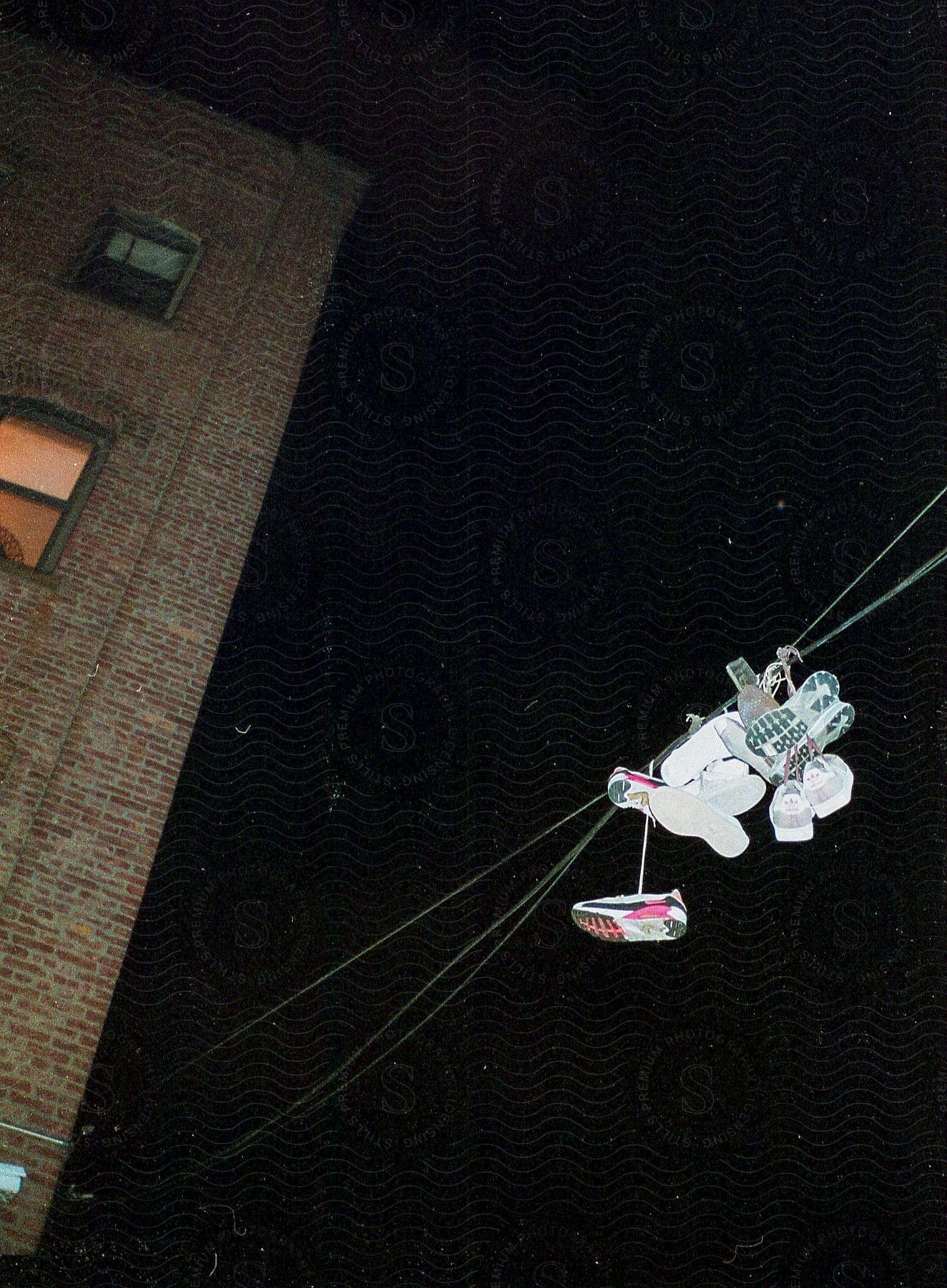 Shoes hanging from a wire against a starry night sky