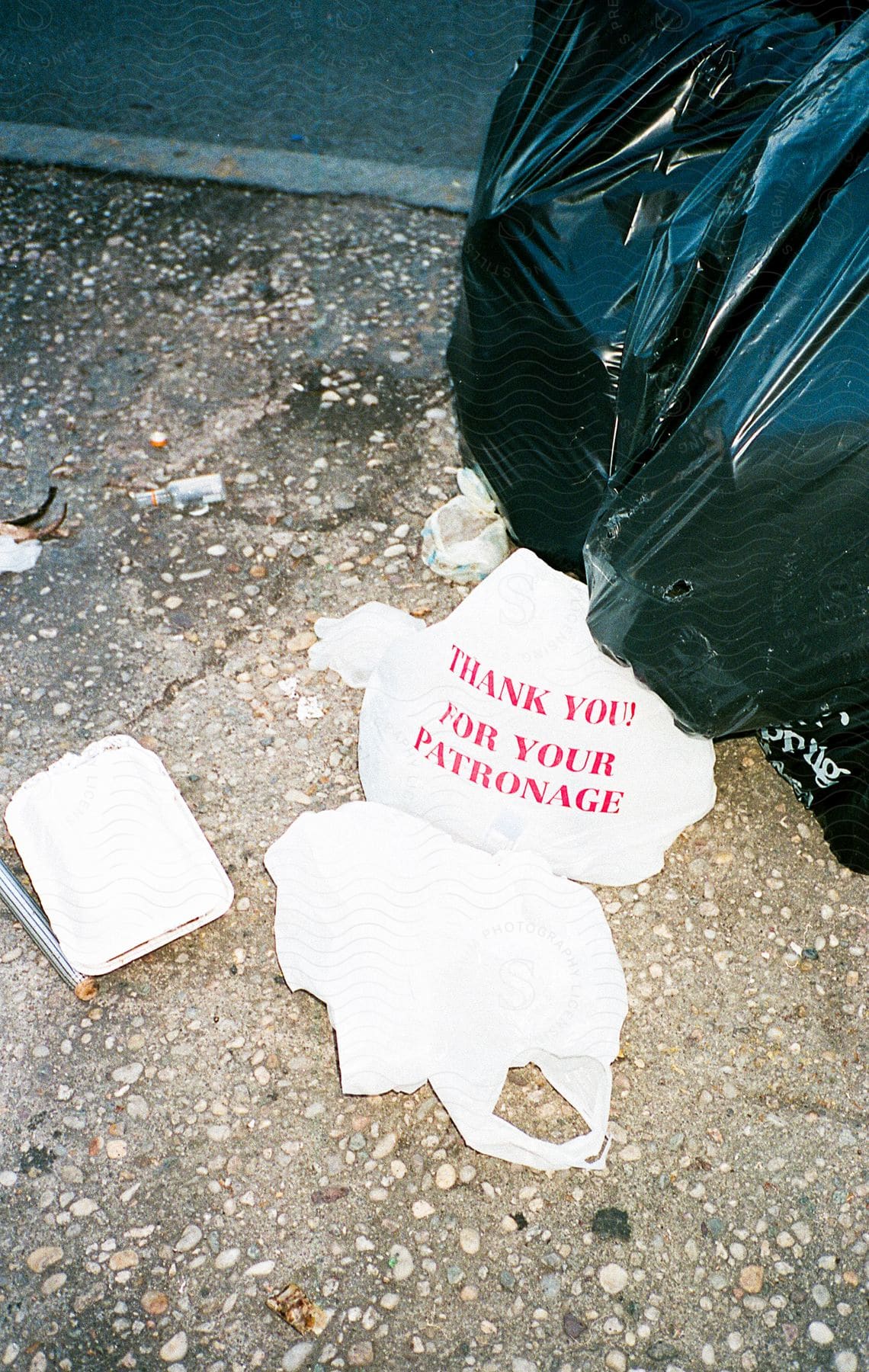 Plastic garbage bags on a sidewalk