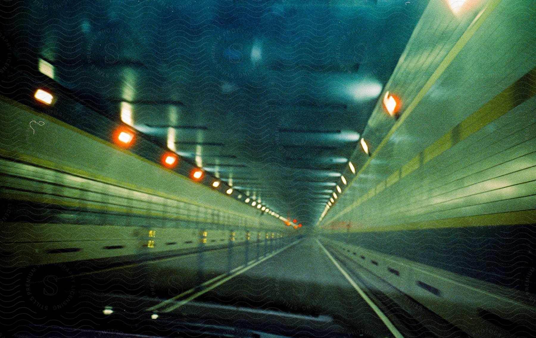 Car driving through a tunnel on a motorway at night