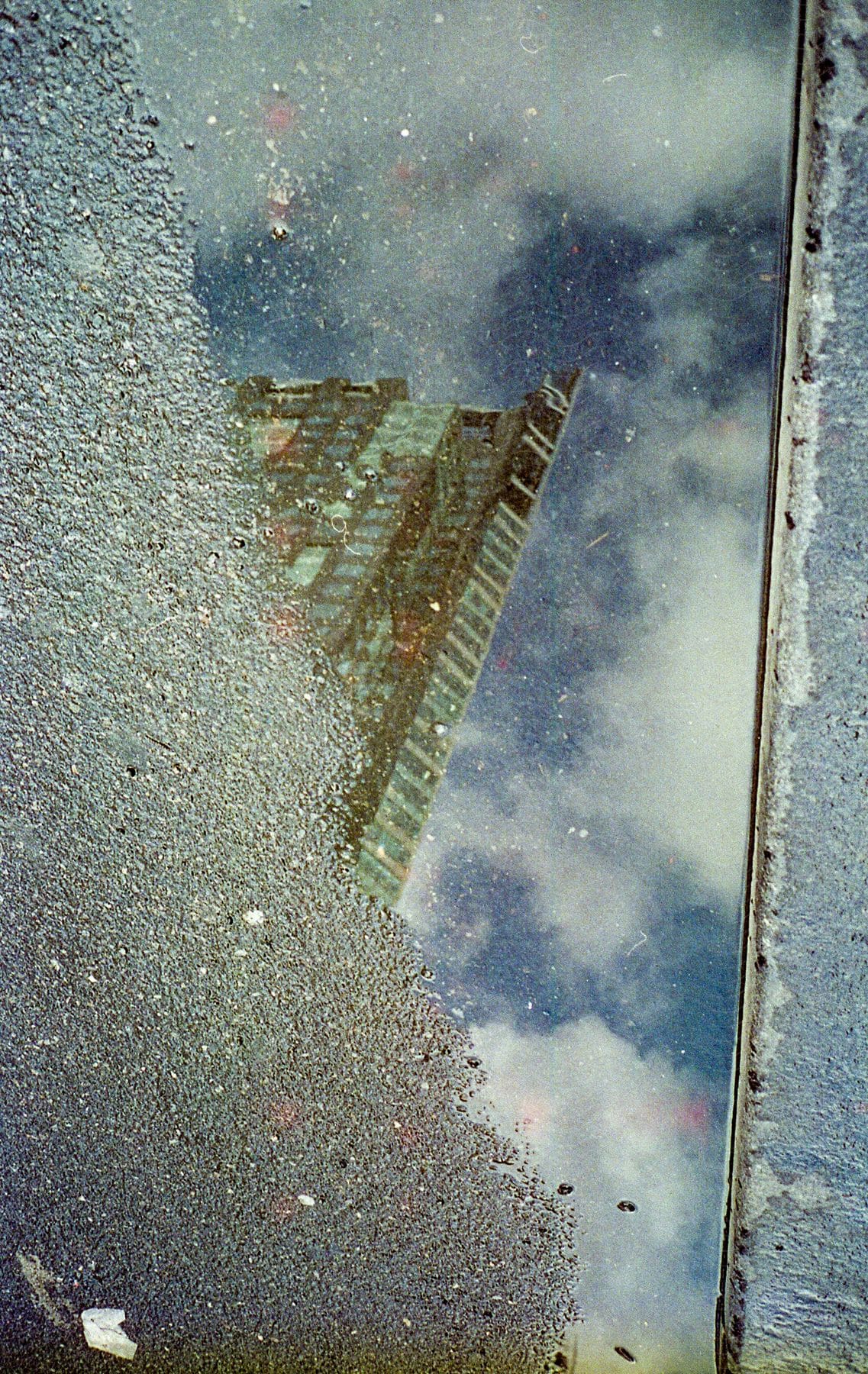 Water puddle reflecting a building on the floor