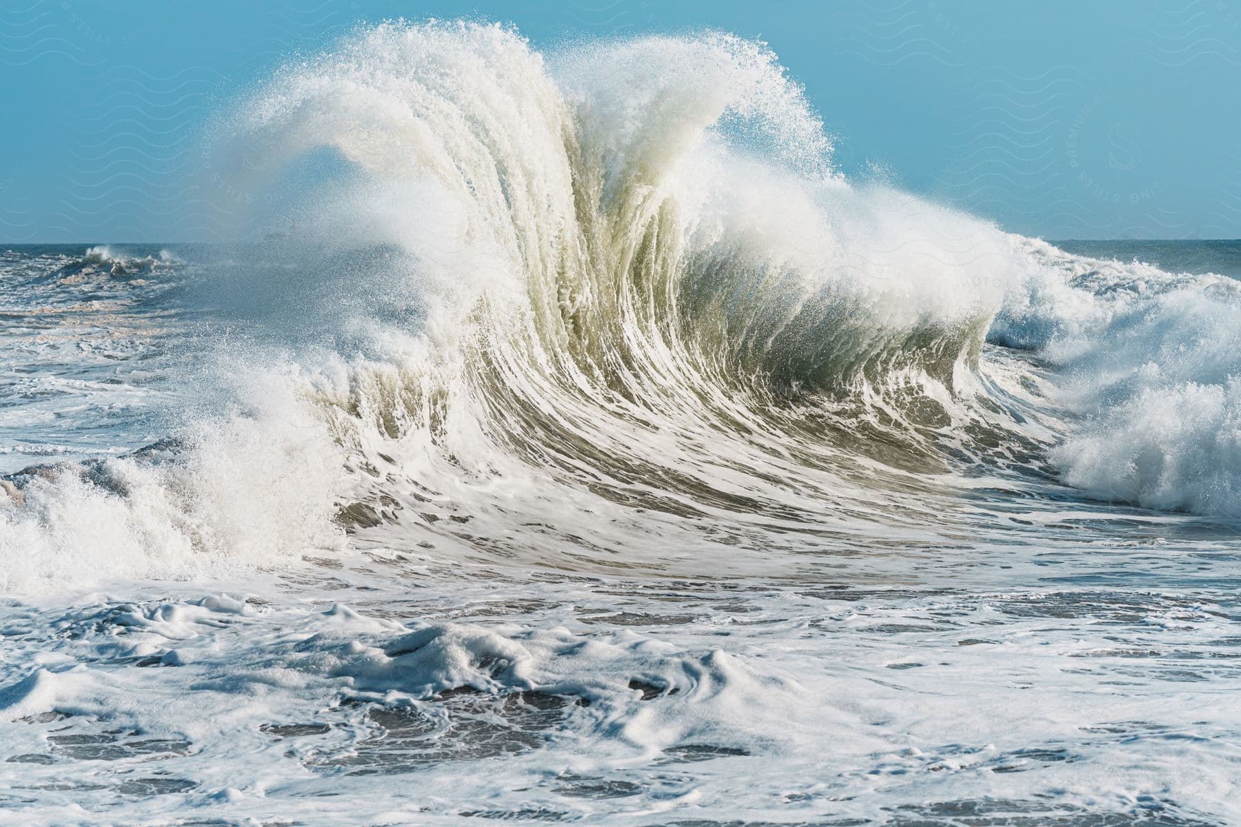 A Seiche Wave Splashing Up Against The Ocean On A Sunny Day