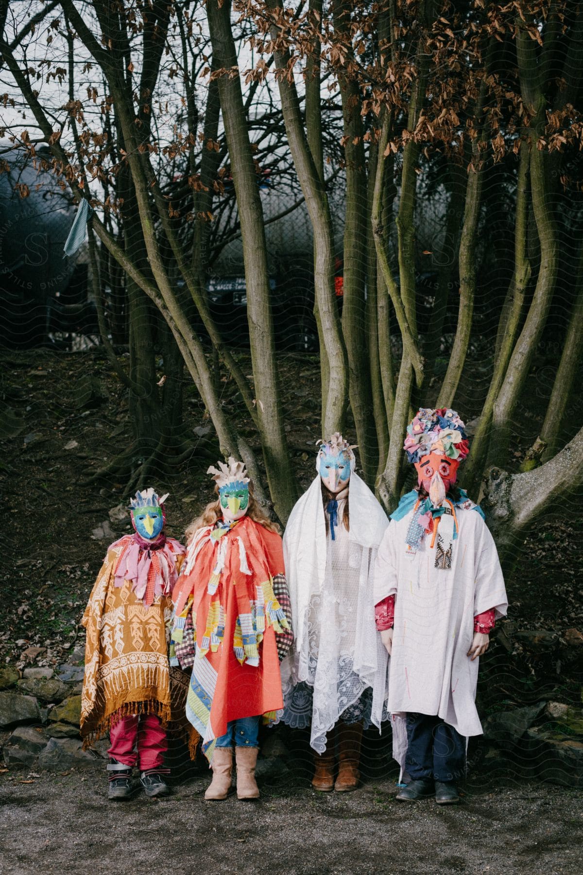 Children wearing funny costumes pose for a photo in the woods