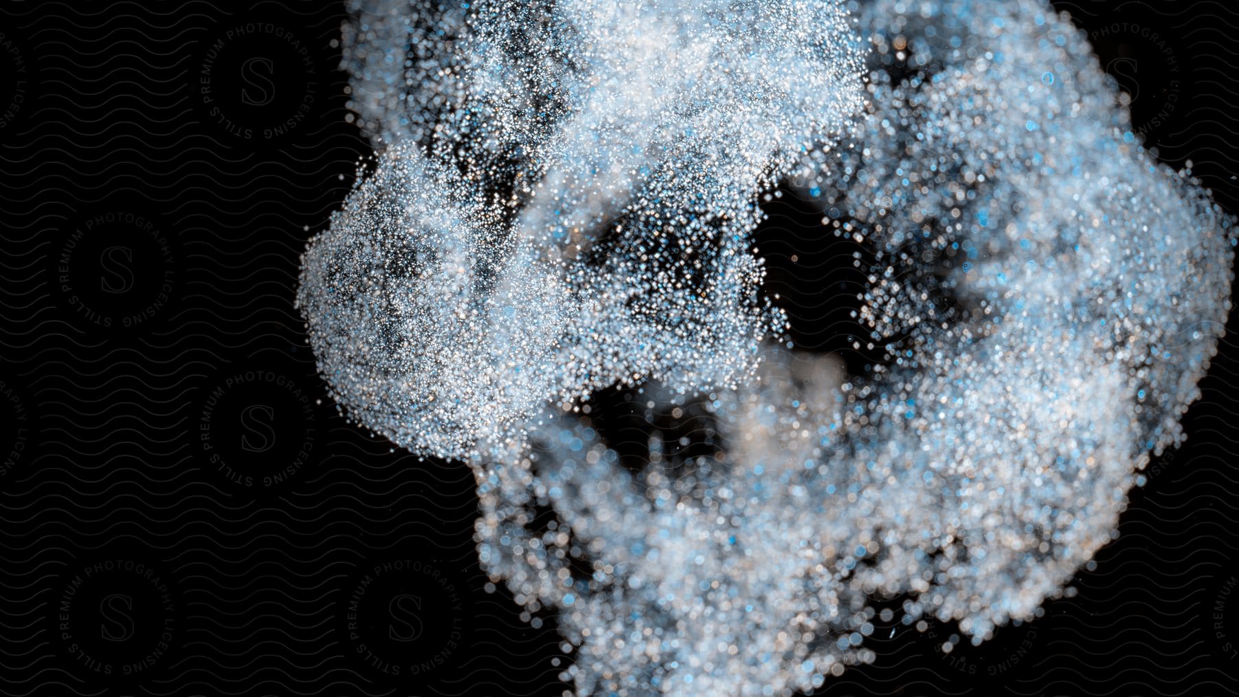 Abstract glitter and particles on a black background