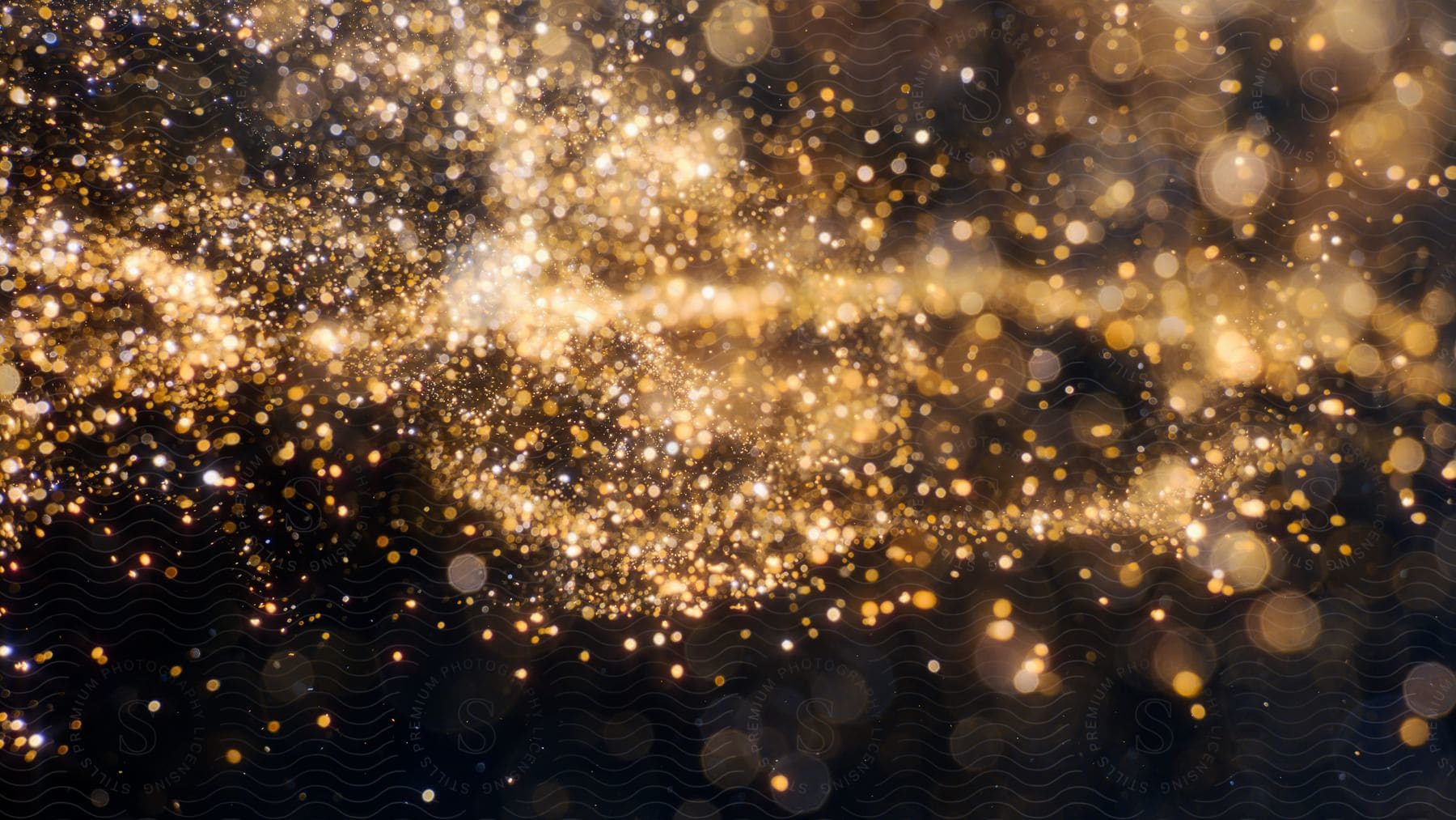 Stock photo of blurred glitter bombs gold glitter defocused abstract twinkly lights