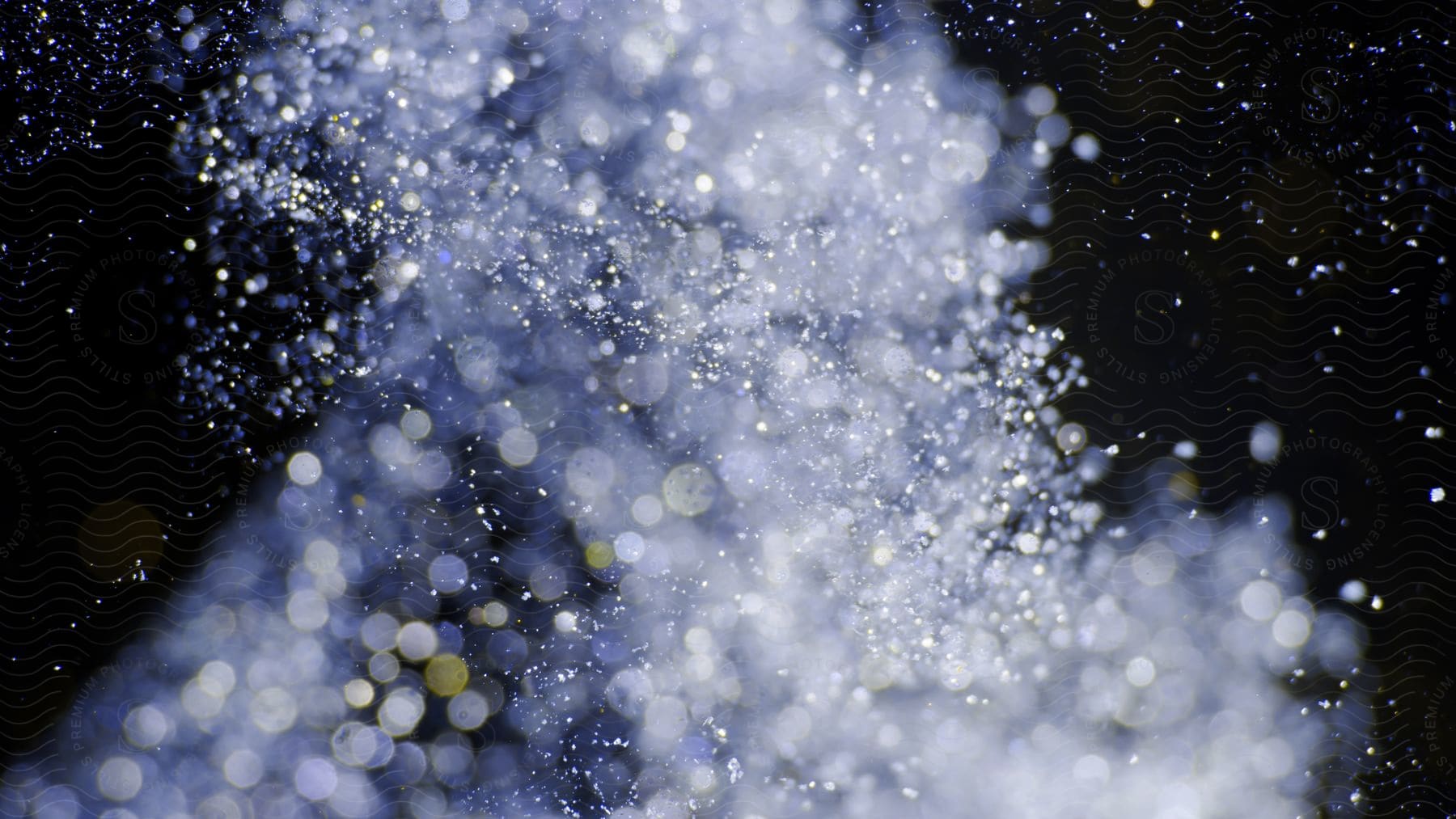 Abstract landscape with glowing dots in a cloud of glitter and particles on a black background