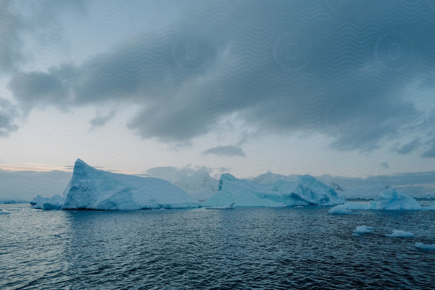 A serene landscape of icy waters and floating icebergs