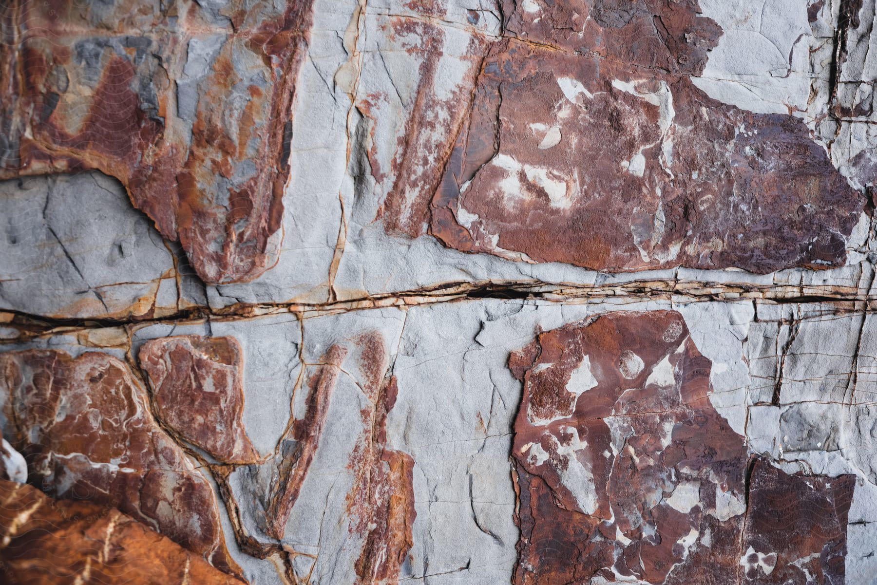 Rocky plain with brown and white spots with yellow lines