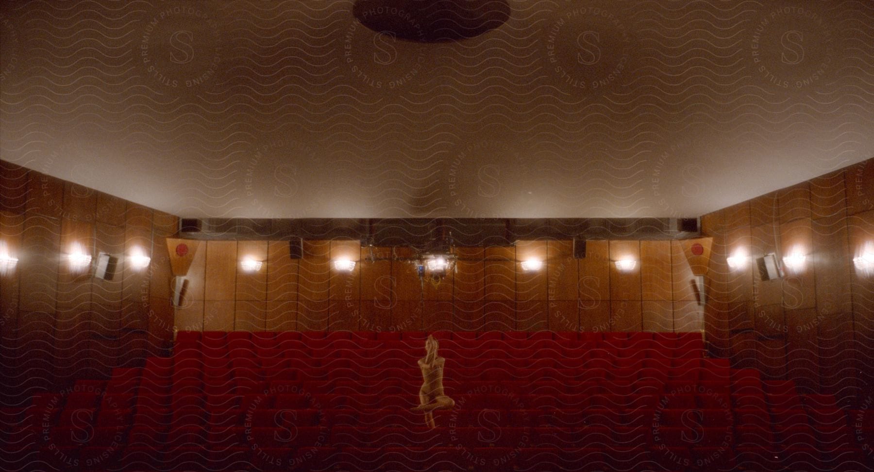 A woman stands in a dance pose in an empty theater