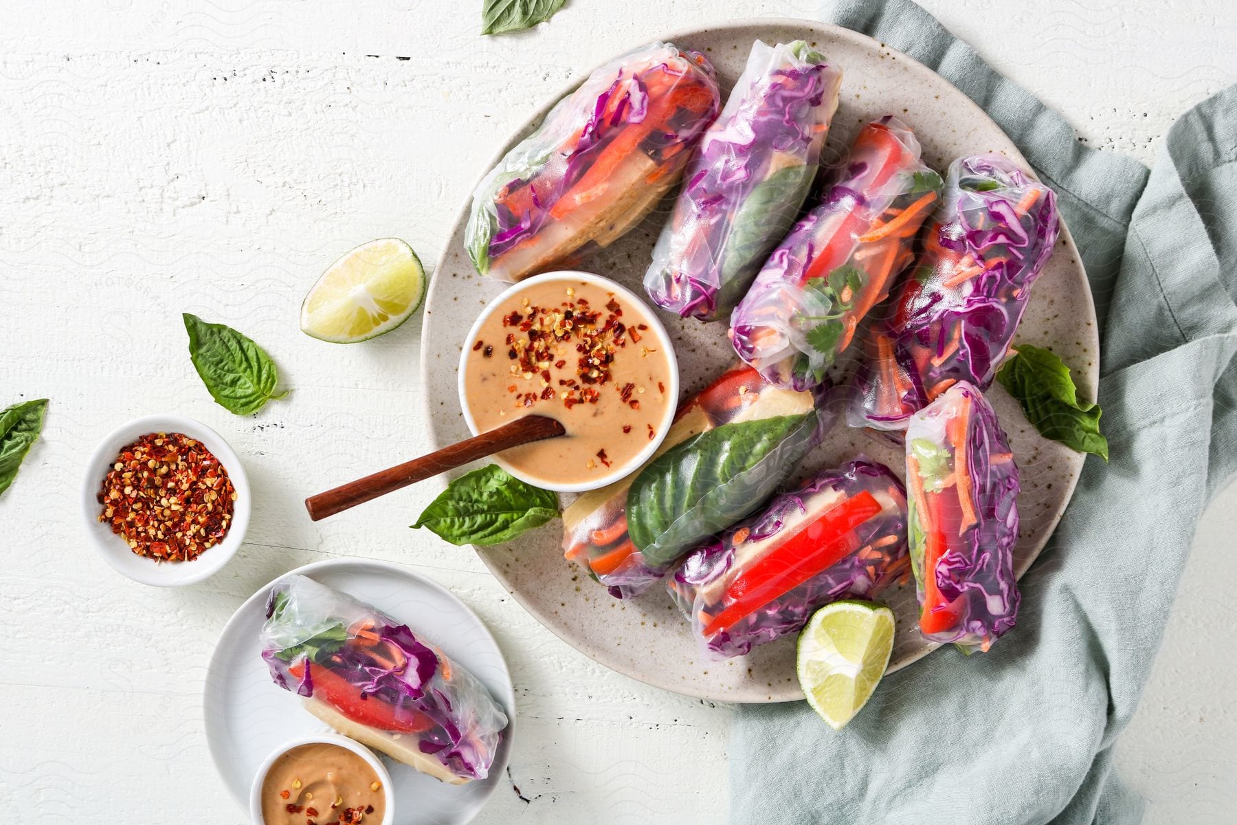 Vegetable rolls with lime slice and sauce on a plate