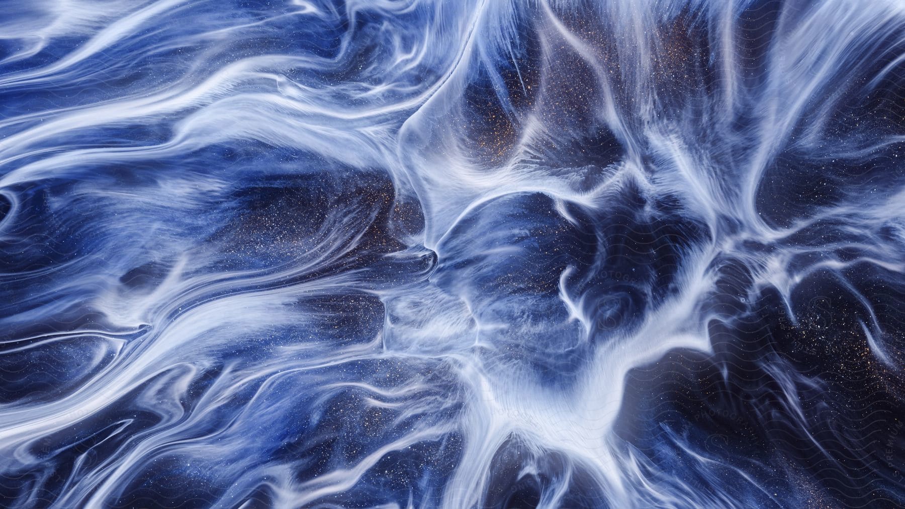 Abstract liquid marble art painting with a blackblue background and spilled white acrylic paint