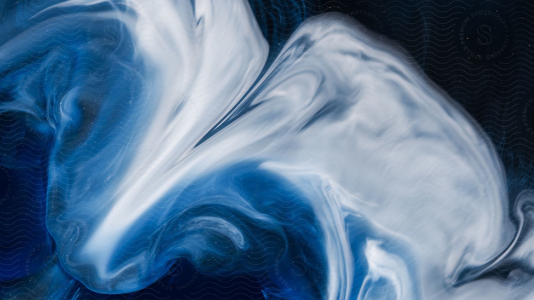 Abstract liquid marble art painting with blackblue background and spilled white acrylic paint
