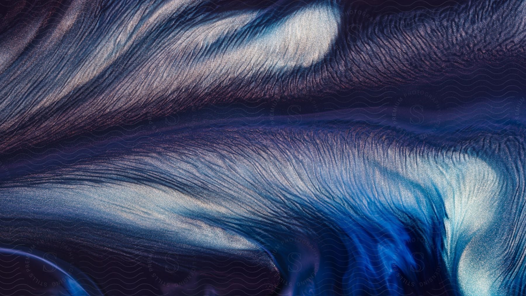 Tiny hairs on the stem of a blue white and purple feather