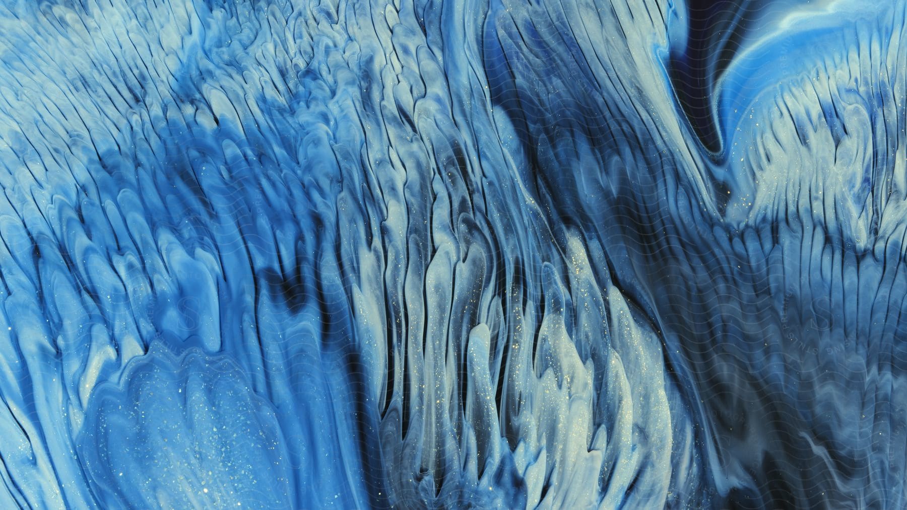 Abstract blue wave pattern created with paint and water colors resembling a colorful sky at night with stars