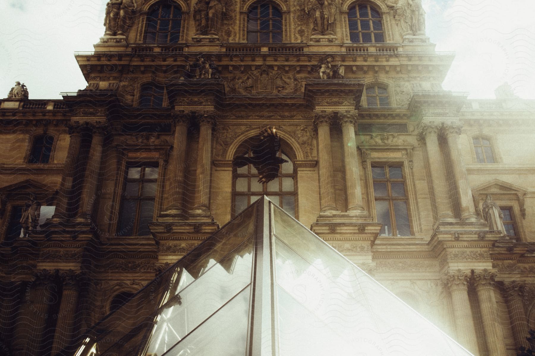 The glass pyramid at the louvre palace in paris during the day