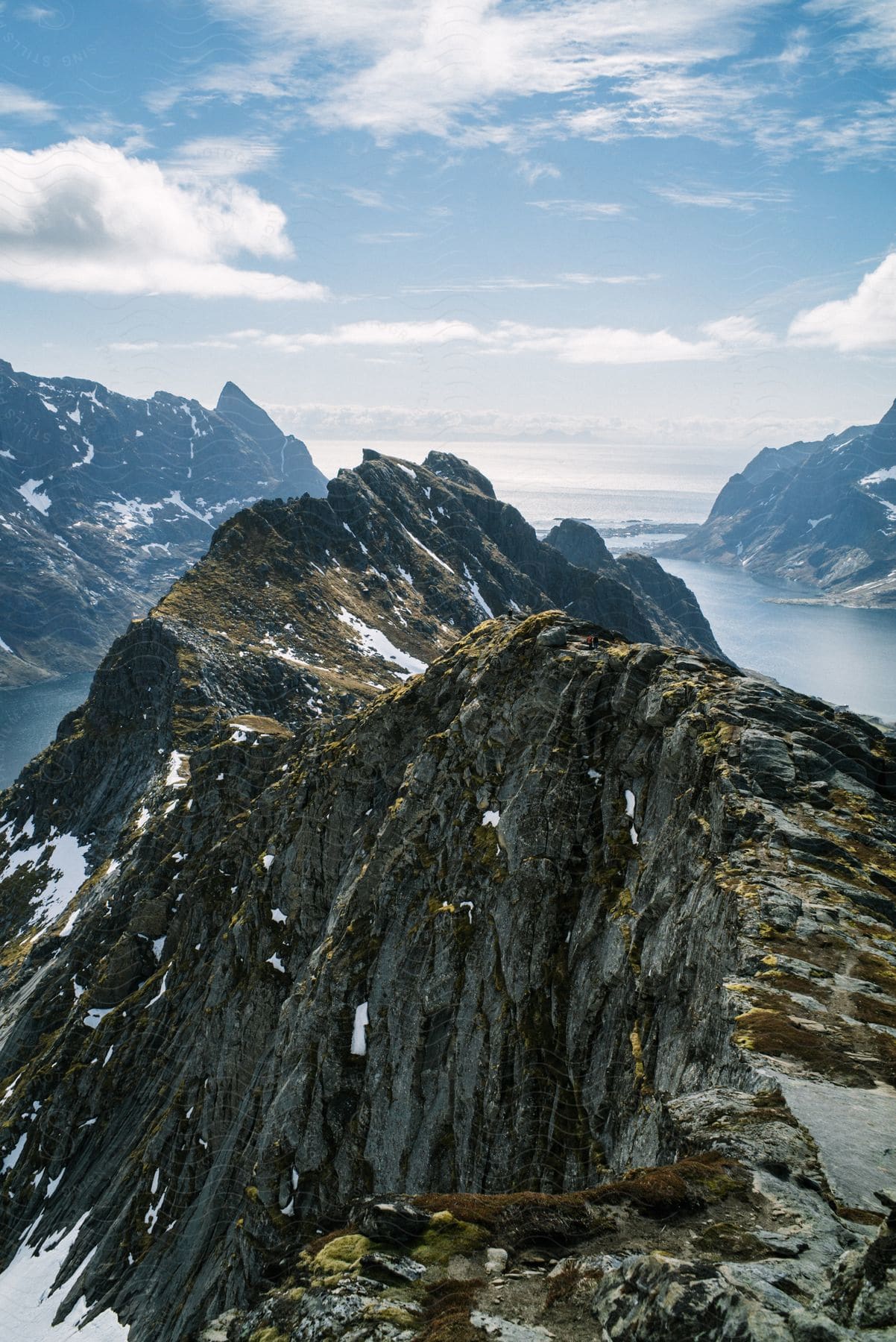 Landscape of rocky mountains with ocean in the background on the horizon