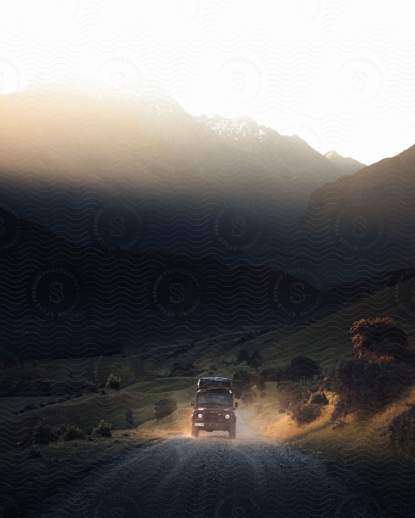 A car driving on a mountain road during dusk