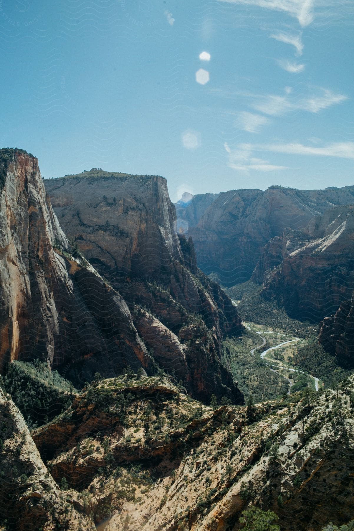 A serene mountain landscape with cliffs and canyons surrounded by vegetation