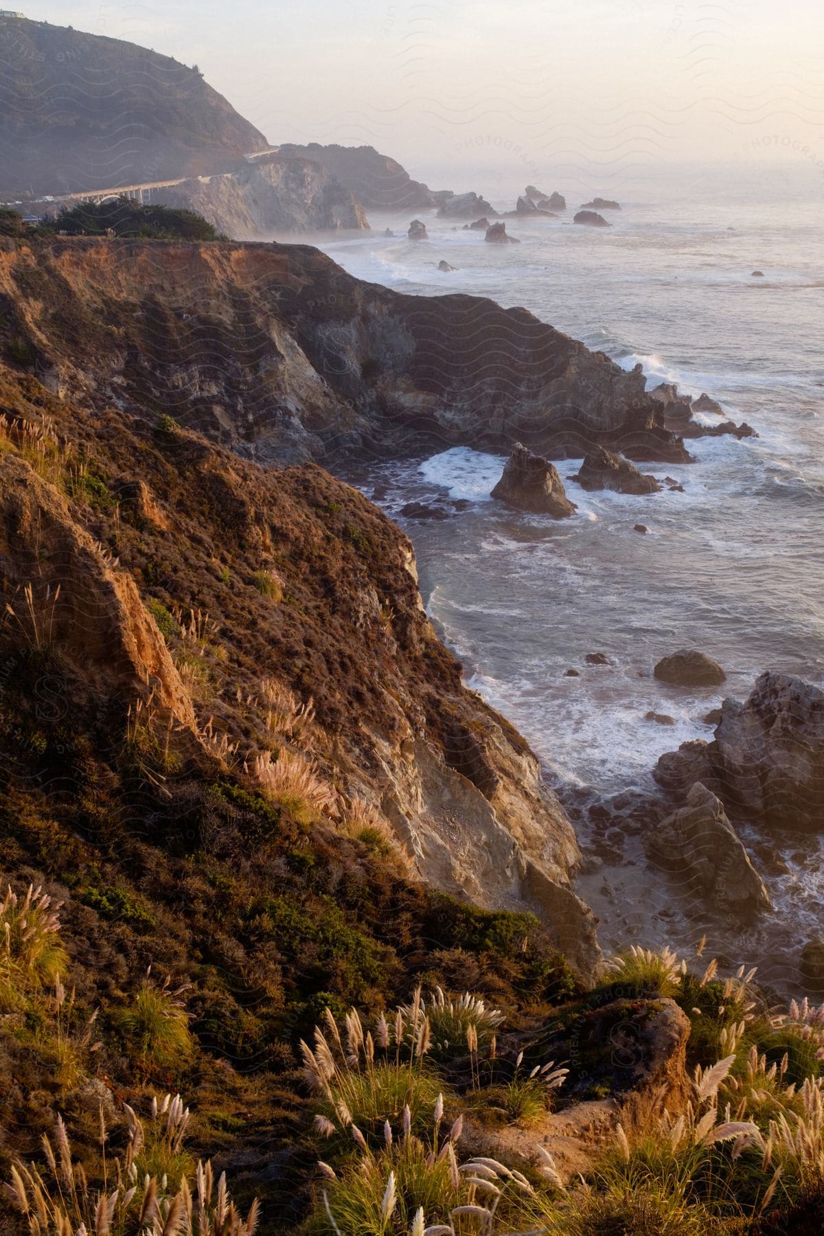 A foggy day reveals a rocky coast along the shoreline