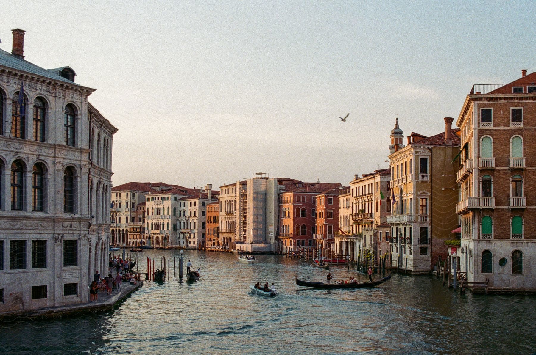 Canal landscape in an urban city with canoes in the water