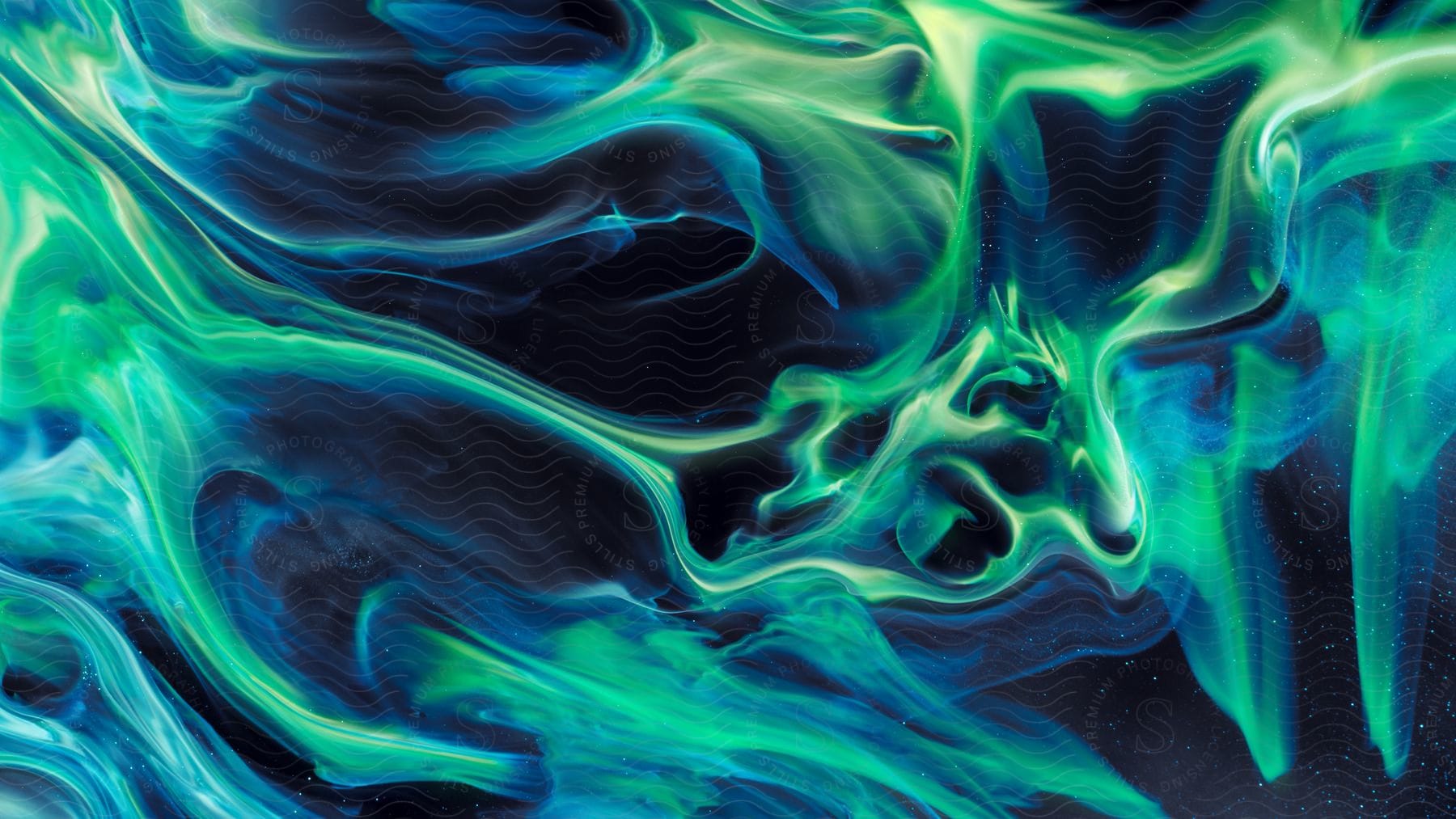 In the galaxy green and blue wavy smoke forms against a black background accompanied by countless small white dots