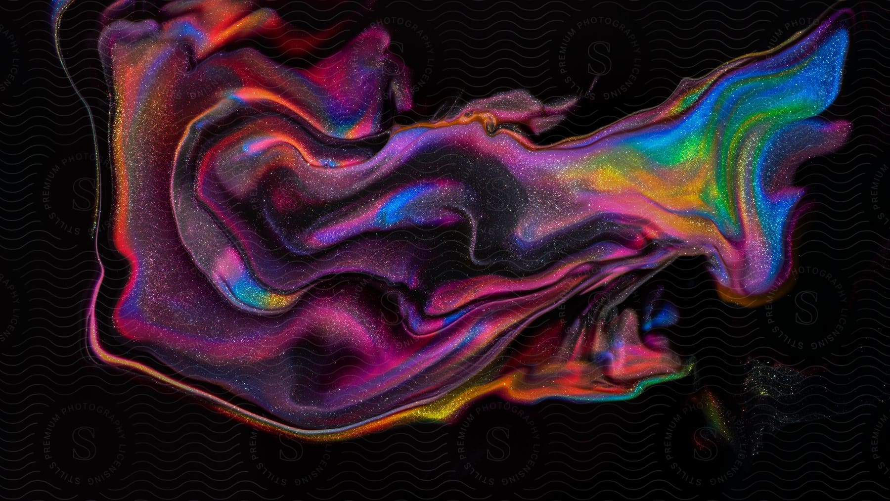 Stock photo of shimmering multicolor fluid on a neon background