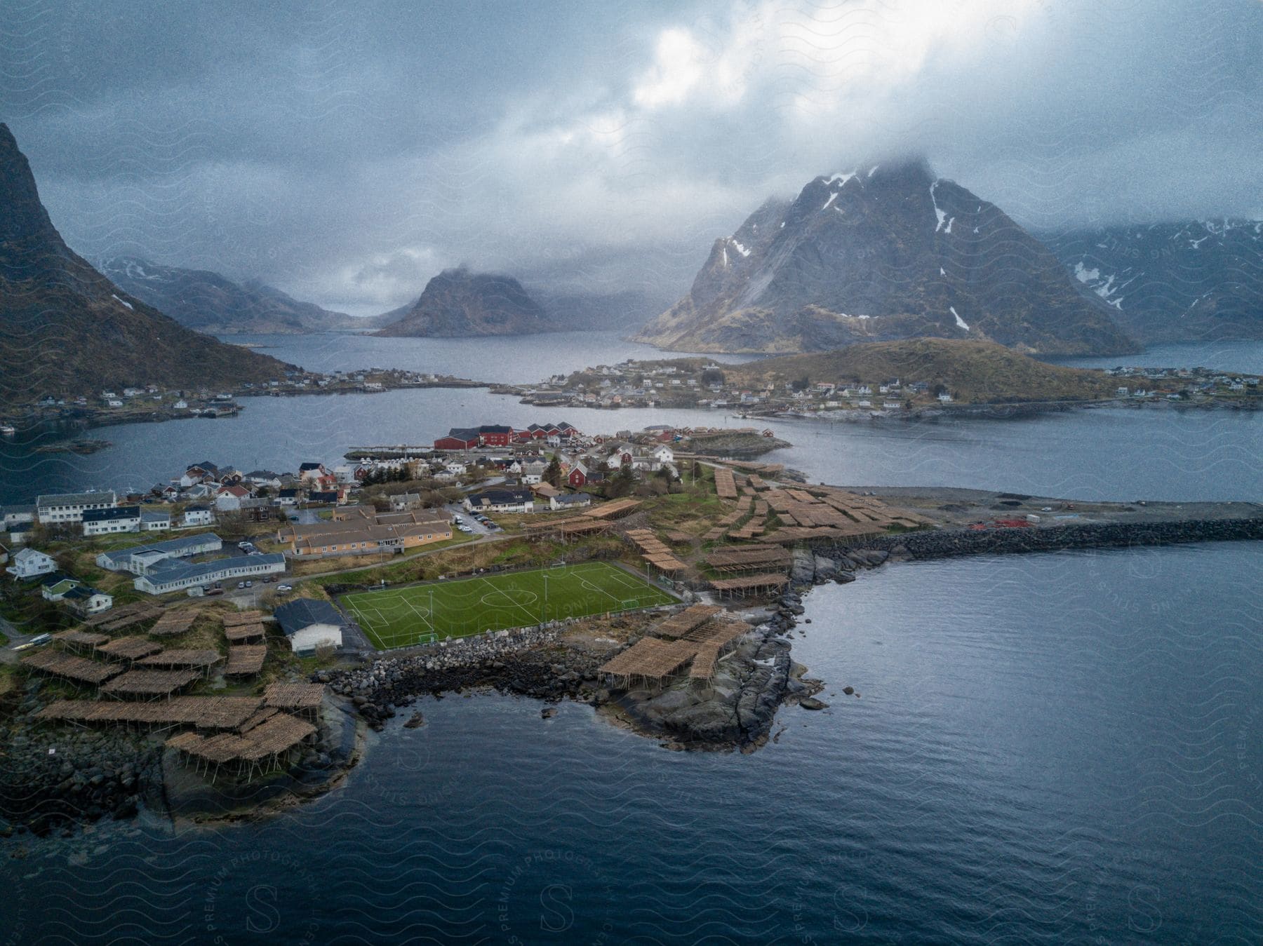 Aerial shot of reine town surrounded by mountains on a cloudy day in lofoten norway