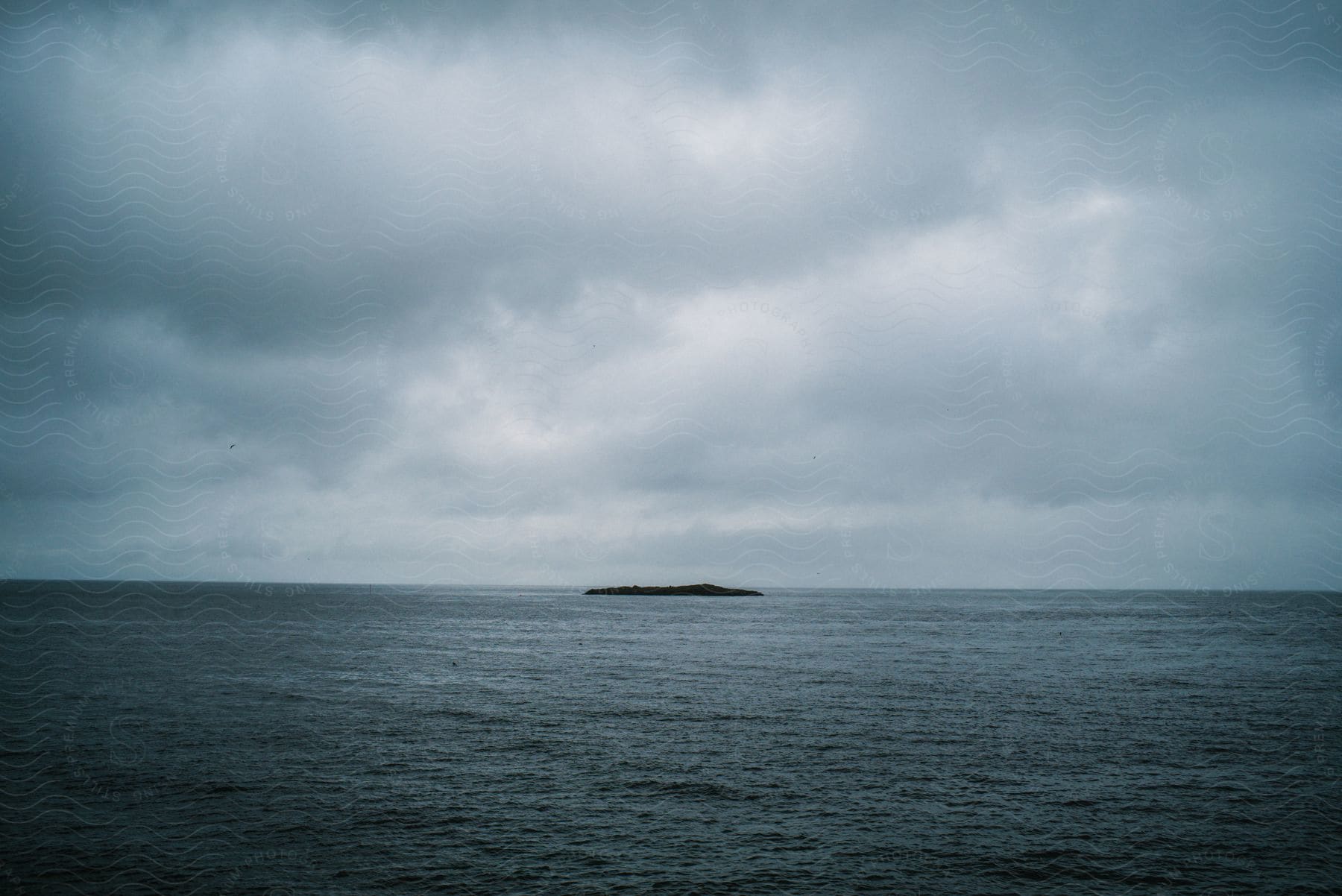 Open sea landscape with a small relief of land in the middle of the ocean