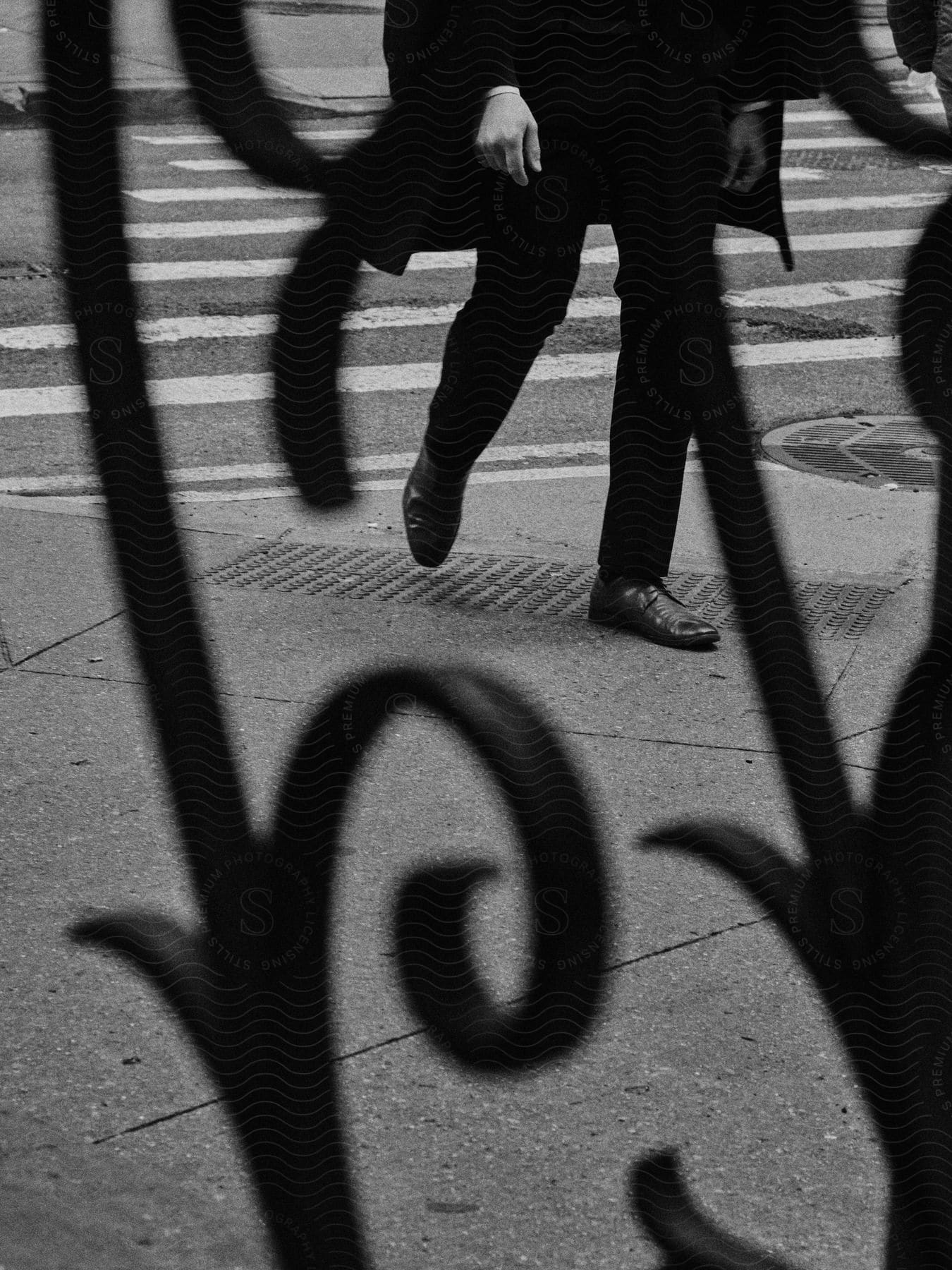 A man confidently walks in a specific direction wearing sturdy black shoes