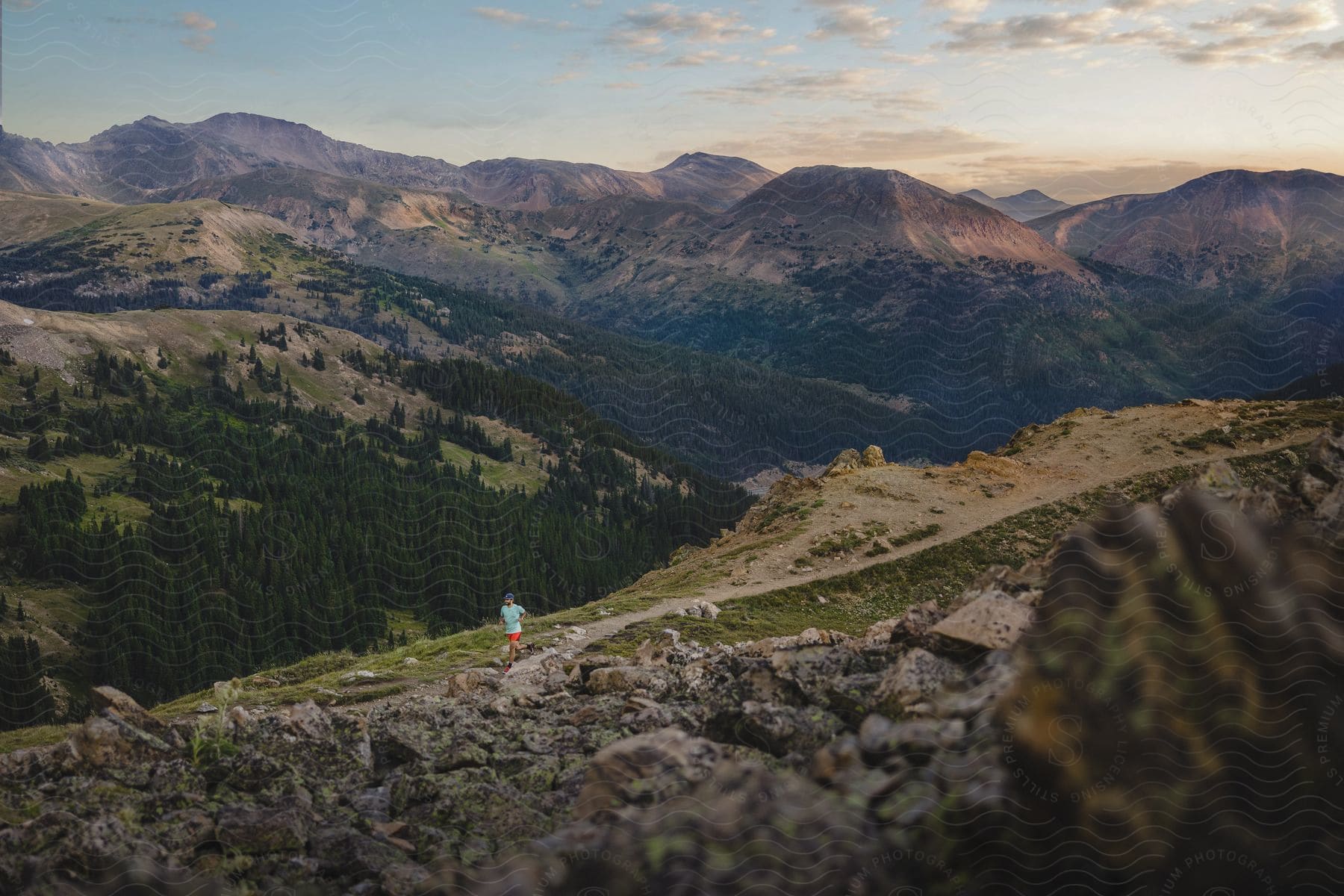 A man running on a mountain during the day