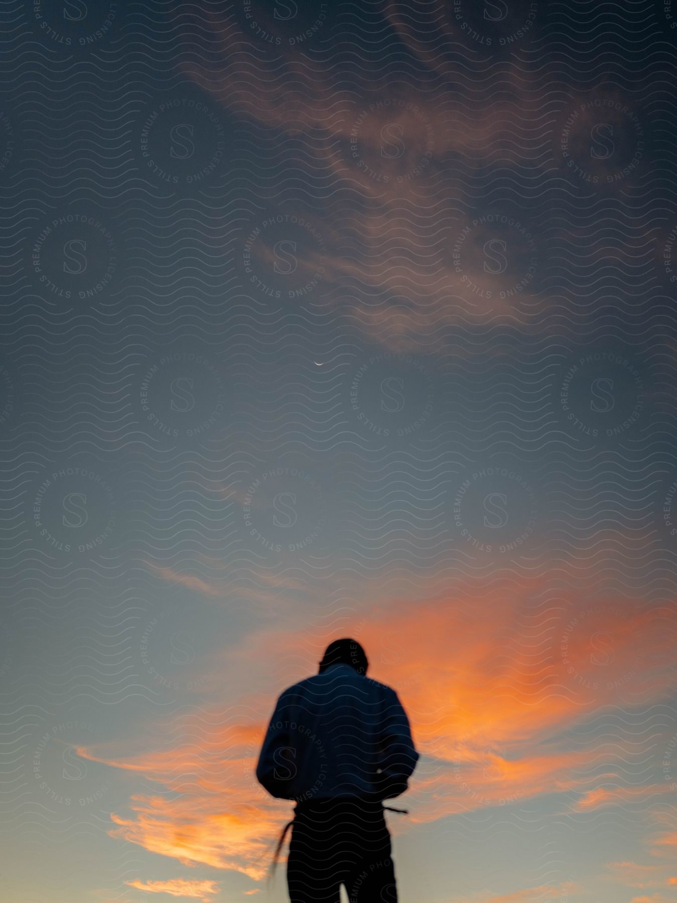 A man standing in nature during a sunset