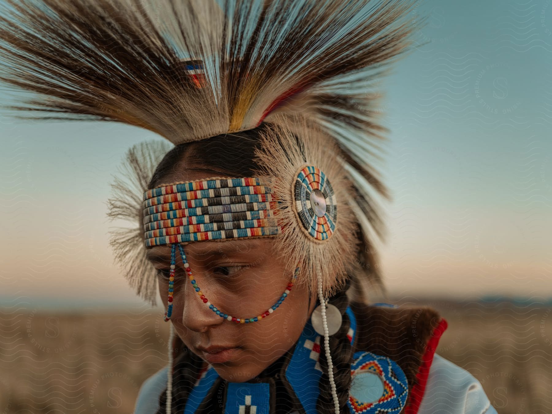 Native american woman wearing traditional clothes in the desert close up of her face