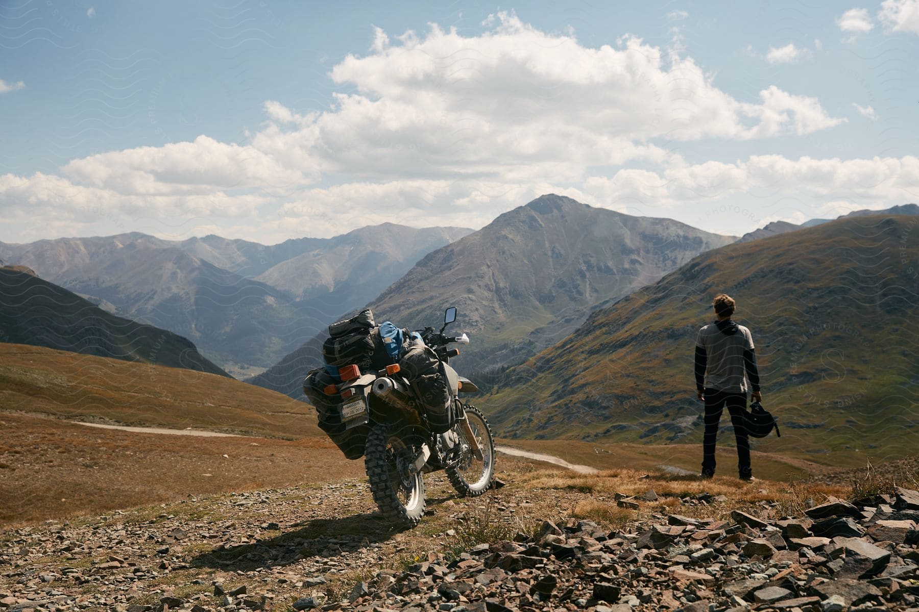 A person riding a motorcycle in the mountains