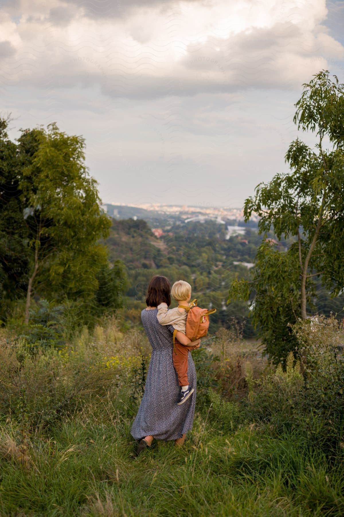 Two people in nature surrounded by grass and trees with a happy and natural landscape