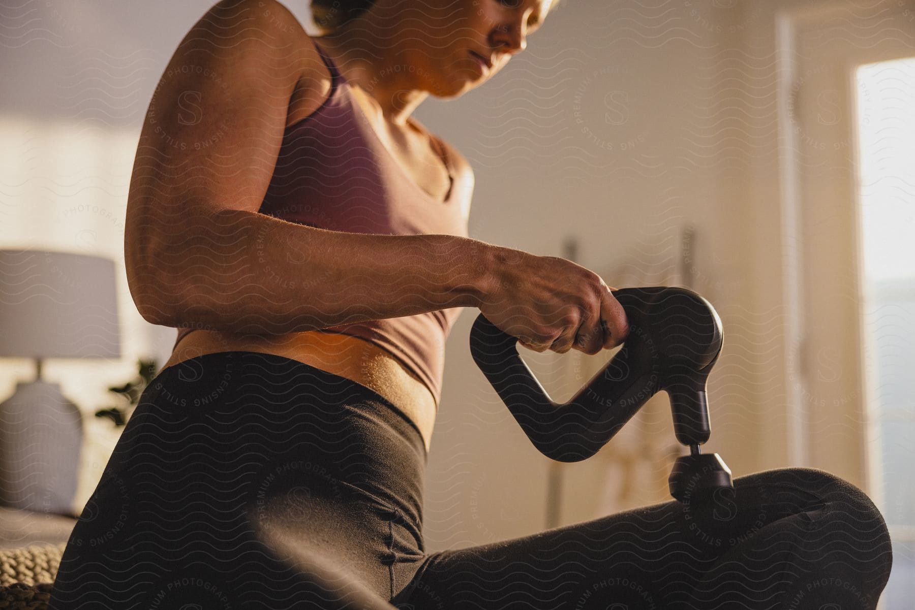 A woman using a medical device for muscle massage