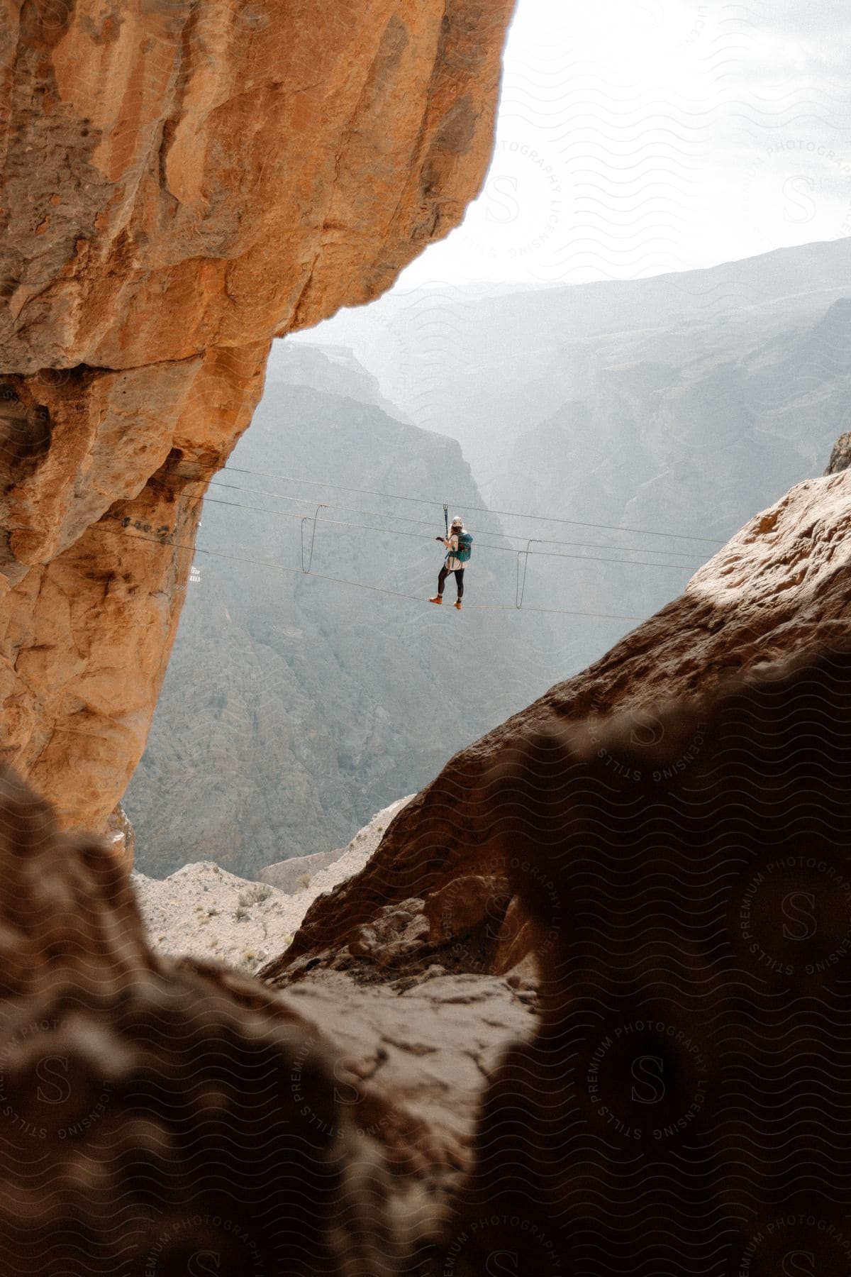 A man climbing a mountain in cloudy weather