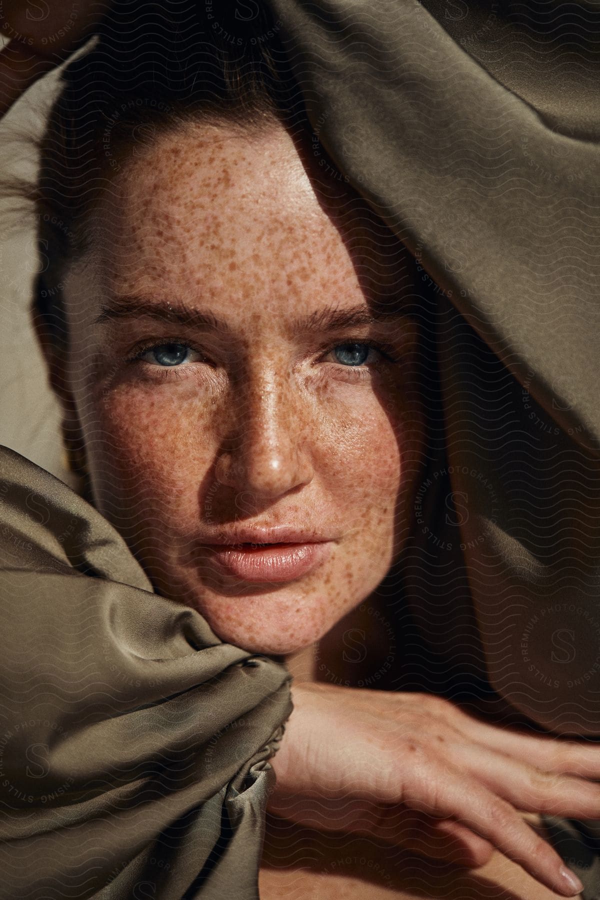 A resilient woman with a weathered face and covered head exudes strength and character in a striking image