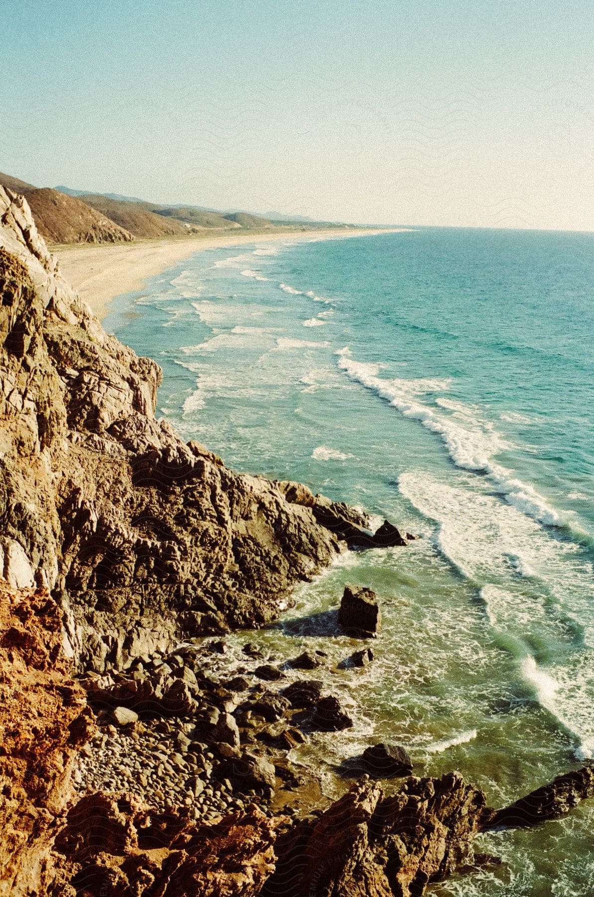 A serene coastal landscape with rocks and waves